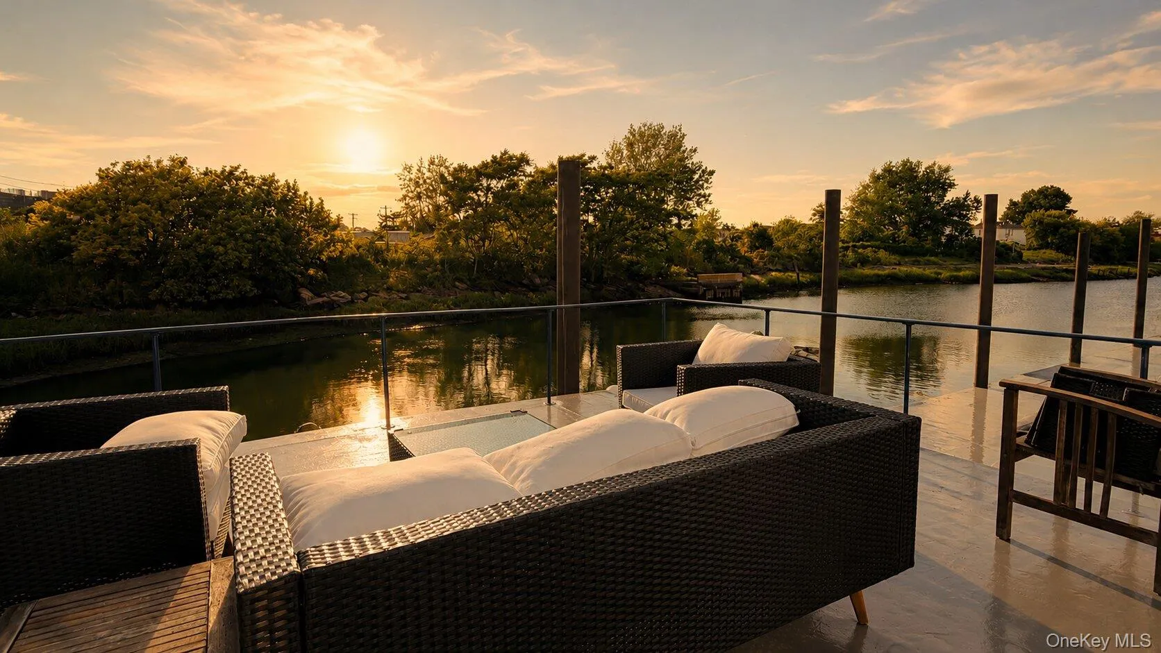 Waterfront roof deck with a sleek glass railing overlooking a natural water feature Waterfront roof deck with a sleek glass railing overlooking a natural water feature