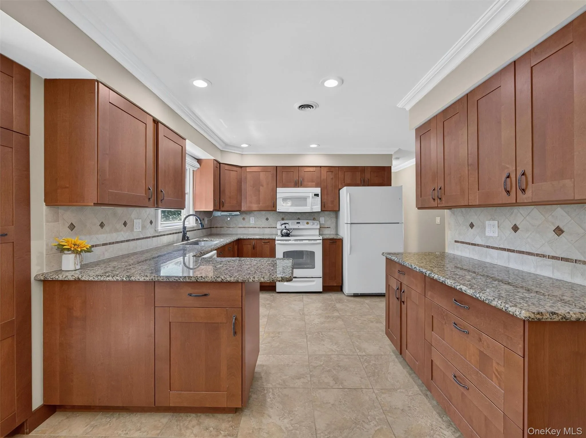 The spacious eat-in kitchen offers abundant cabinetry, generous counter space, and a layout designed for everyday living and memorable gatherings. The spacious eat-in kitchen offers abundant cabinetry, generous counter space, and a layout designed for everyday living and memorable gatherings.