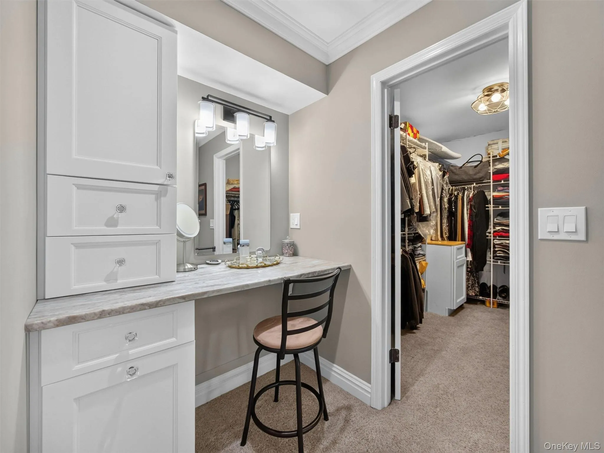Custom built-ins, a dedicated vanity area, and an adjoining walk-in closet create a thoughtfully designed primary suite experience. Custom built-ins, a dedicated vanity area, and an adjoining walk-in closet create a thoughtfully designed primary suite experience.