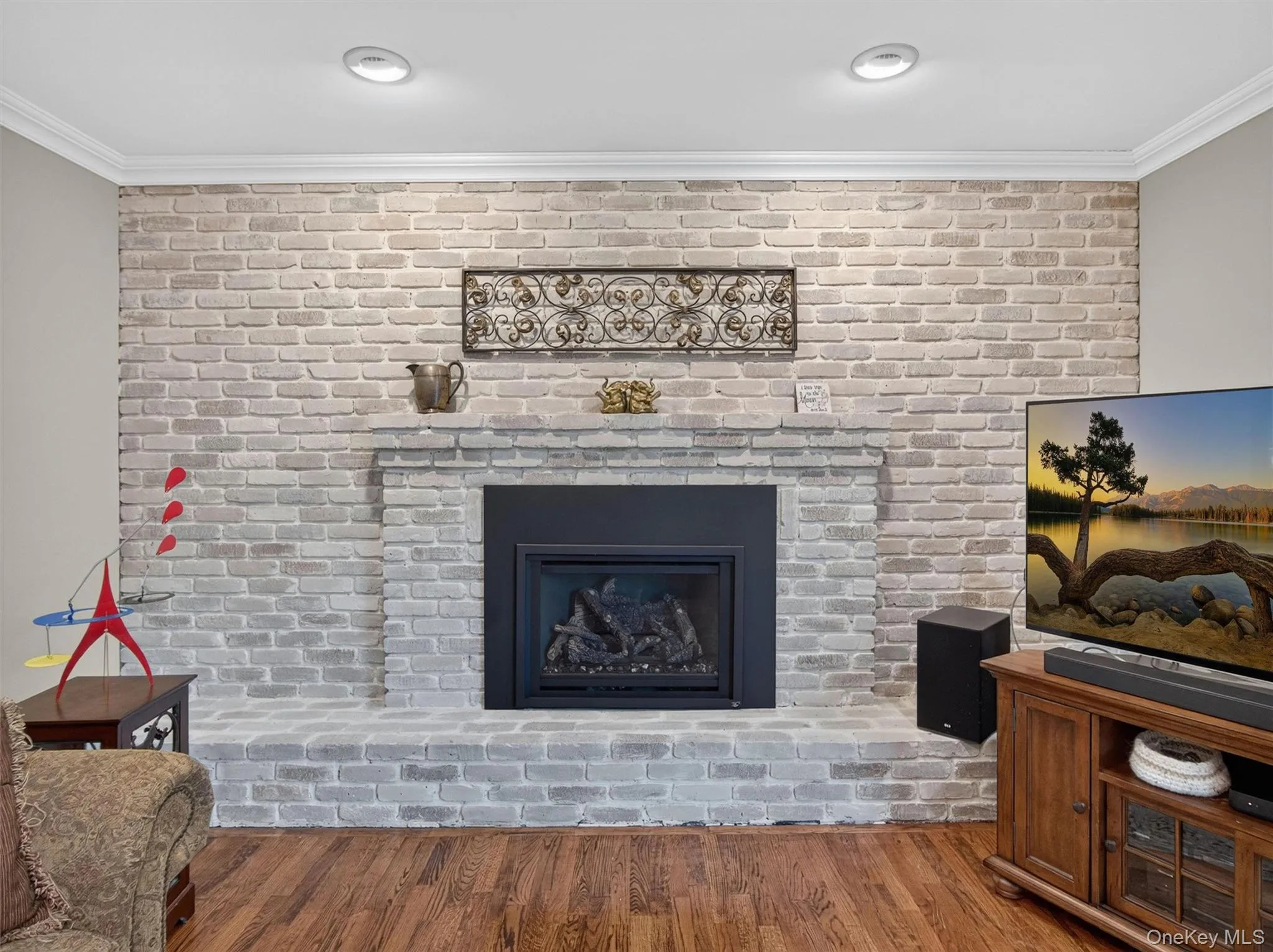 A floor-to-ceiling brick fireplace with gas insert serves as the focal point of this comfortable gathering space. A floor-to-ceiling brick fireplace with gas insert serves as the focal point of this comfortable gathering space.