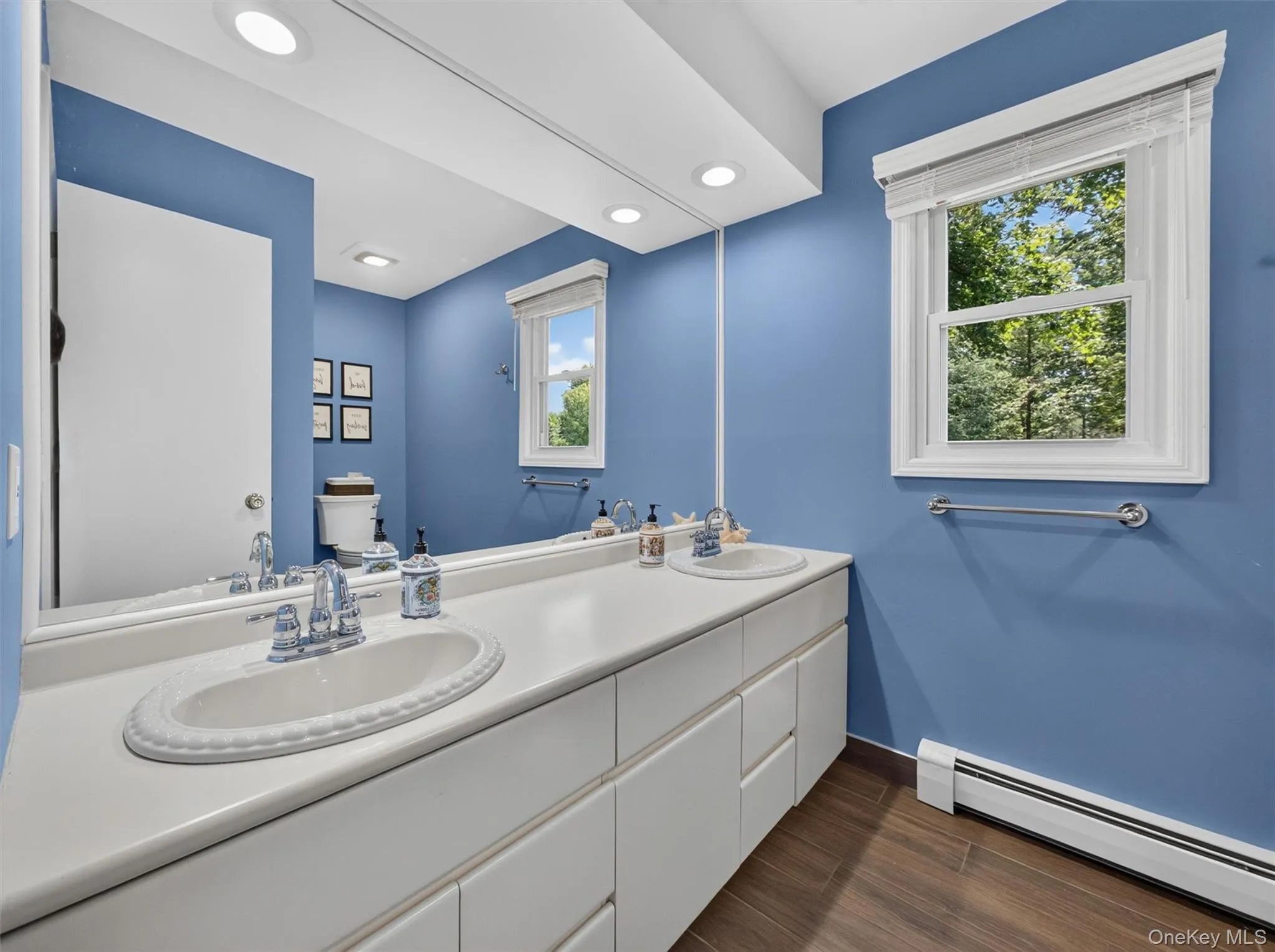 Serving the generously sized secondary bedrooms, this well-appointed bath offers a double vanity, abundant storage, and room for everyday routines. Serving the generously sized secondary bedrooms, this well-appointed bath offers a double vanity, abundant storage, and room for everyday routines.