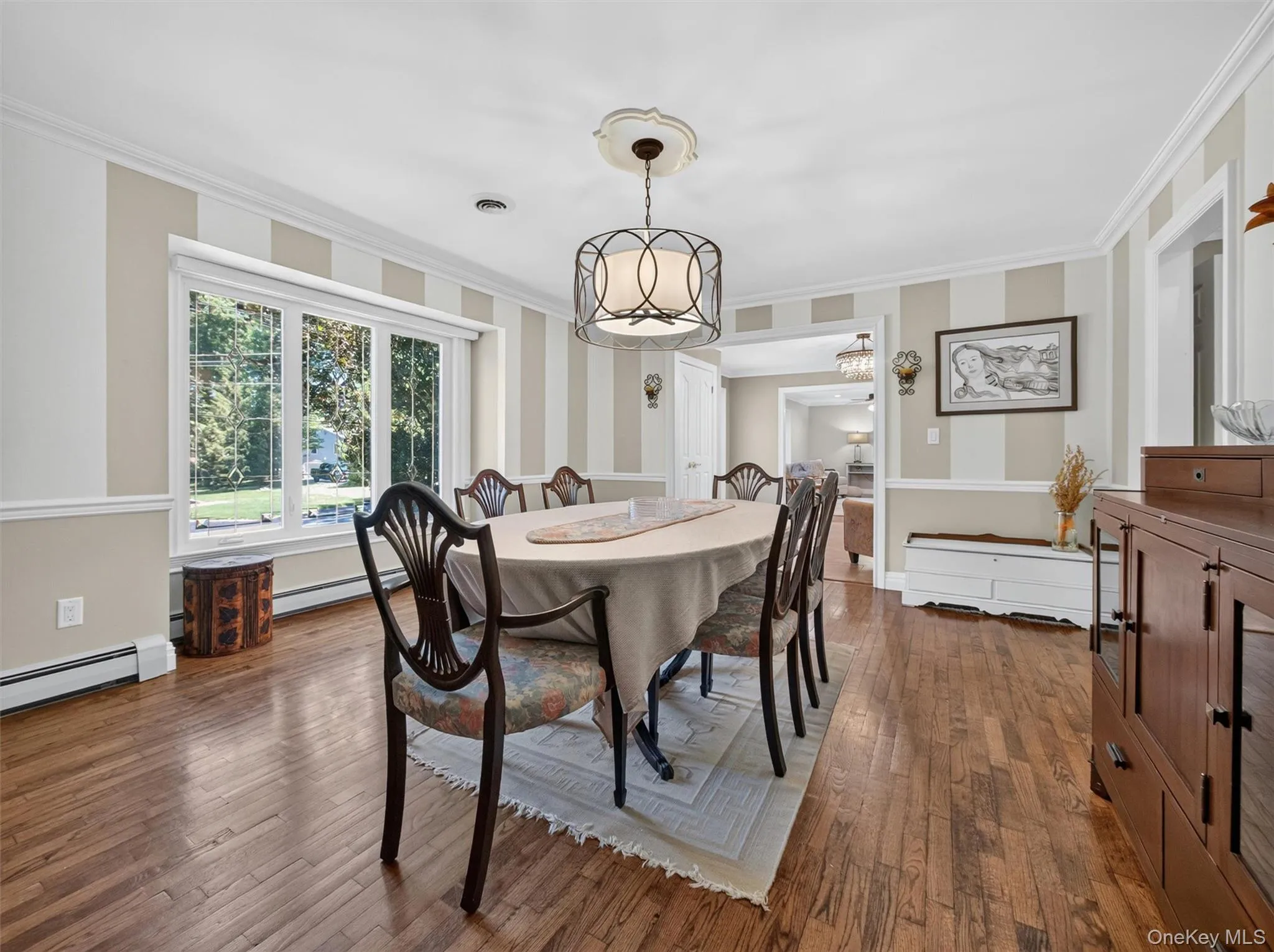 Large windows frame the dining area, creating a bright and welcoming setting for everyday meals and special celebrations alike. Large windows frame the dining area, creating a bright and welcoming setting for everyday meals and special celebrations alike.