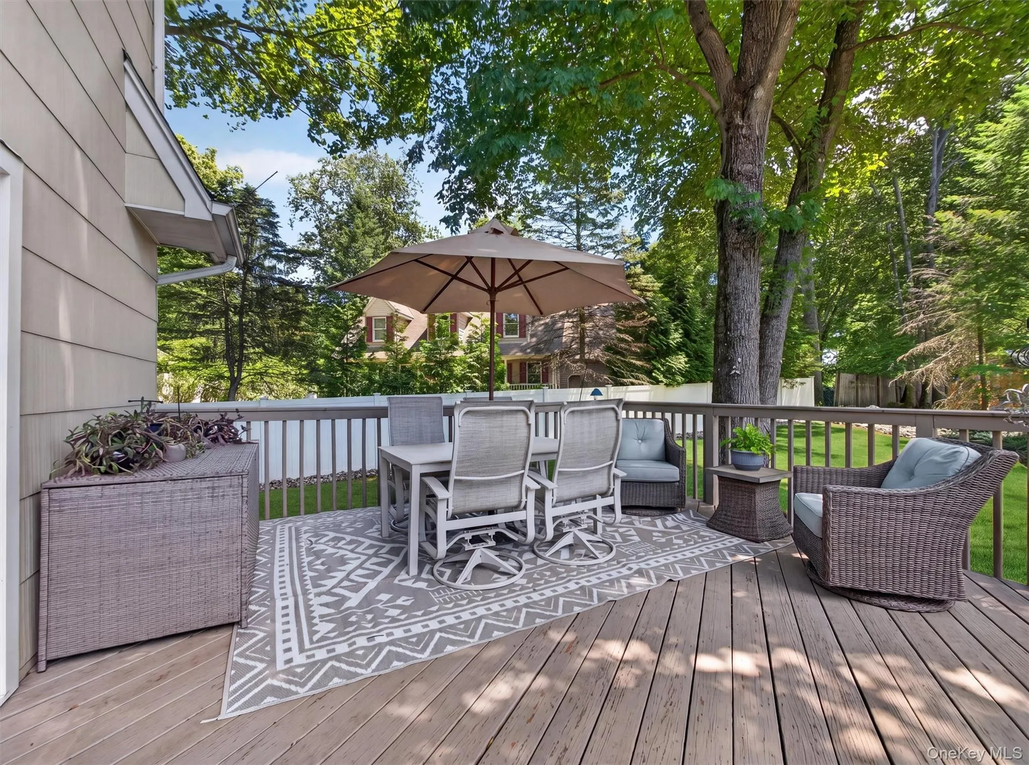 Step outside to a spacious deck overlooking the backyard, offering an inviting setting for outdoor dining, morning coffee, or simply enjoying the surroundings. Step outside to a spacious deck overlooking the backyard, offering an inviting setting for outdoor dining, morning coffee, or simply enjoying the surroundings.