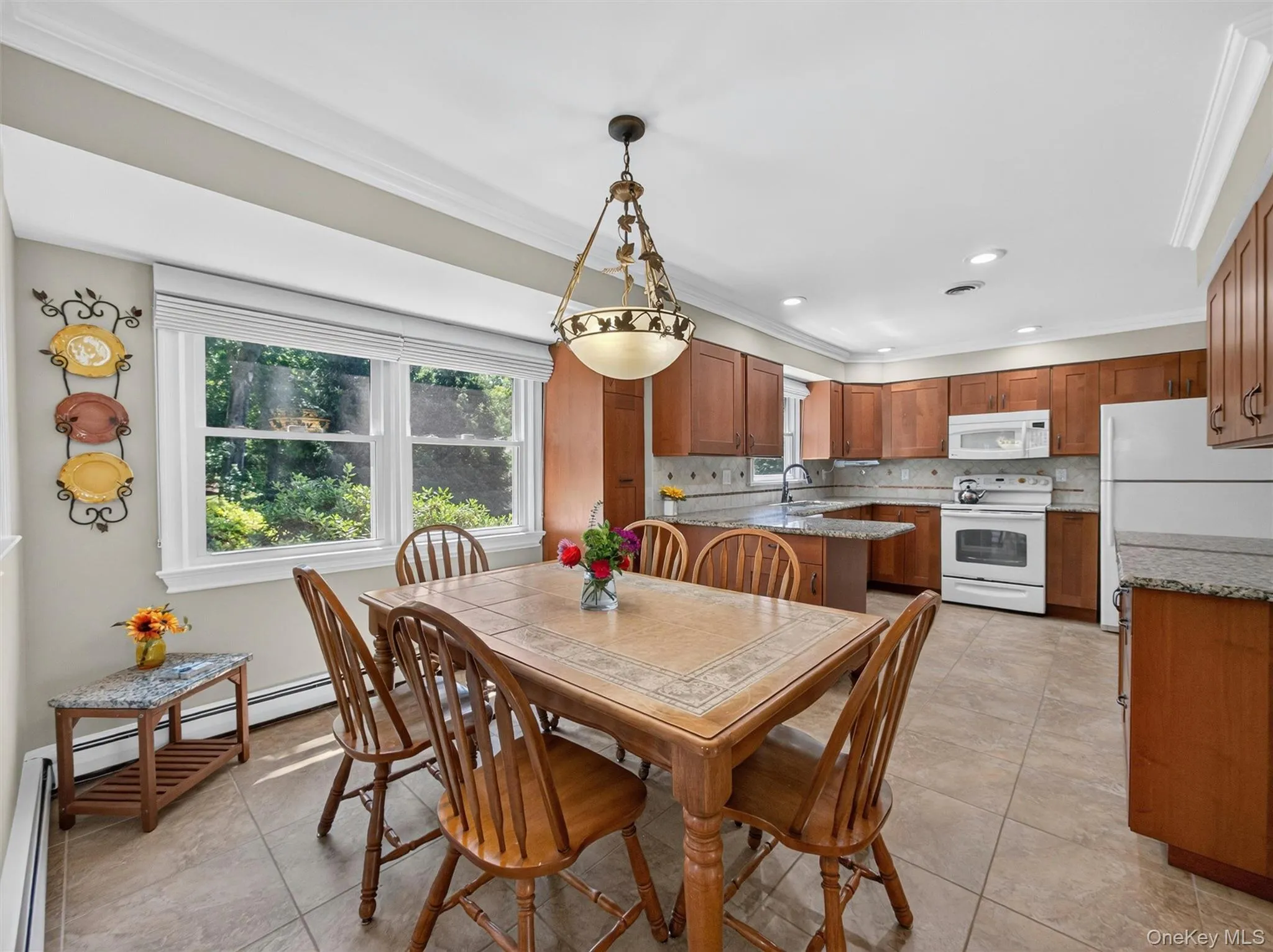 Overlooking the backyard and seamlessly connected to the kitchen, this cheerful dining space serves as the heart of daily life. Overlooking the backyard and seamlessly connected to the kitchen, this cheerful dining space serves as the heart of daily life.