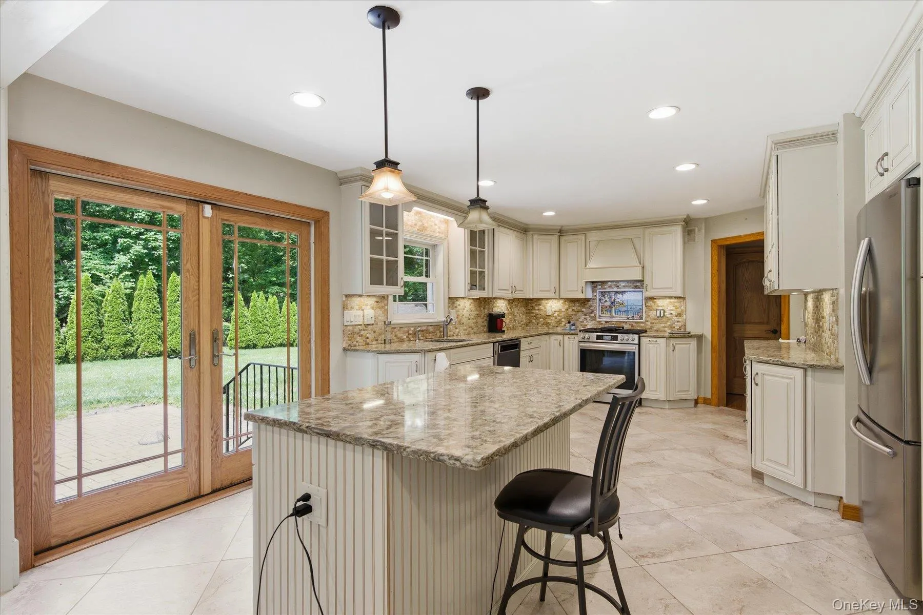 Updated Granite Eat In Kitchen with porcelain tile floors, stainless steel appliances and sliders out to a private yard Updated Granite Eat In Kitchen with porcelain tile floors, stainless steel appliances and sliders out to a private yard