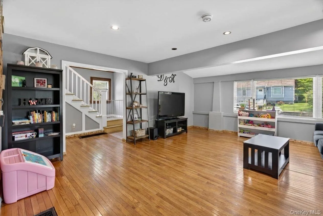 The spacious living room is filled with natural light, creating a bright and inviting atmosphere that feels both comfortable and welcoming The spacious living room is filled with natural light, creating a bright and inviting atmosphere that feels both comfortable and welcoming