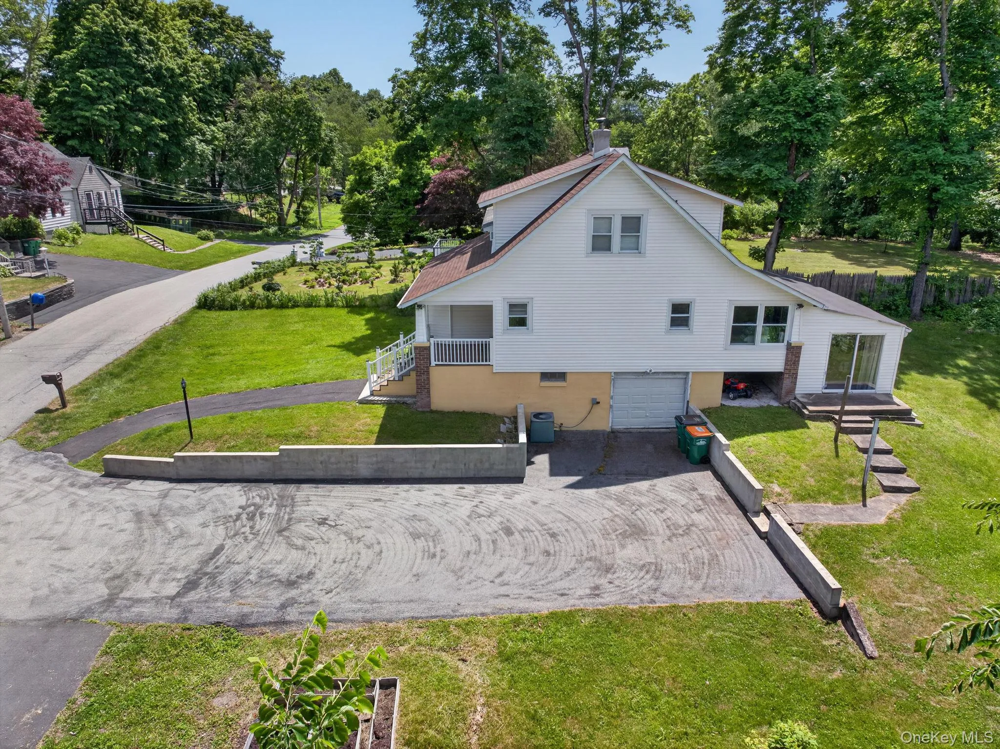 Side of home with large driveway and surrounding walls. Side of home with large driveway and surrounding walls.
