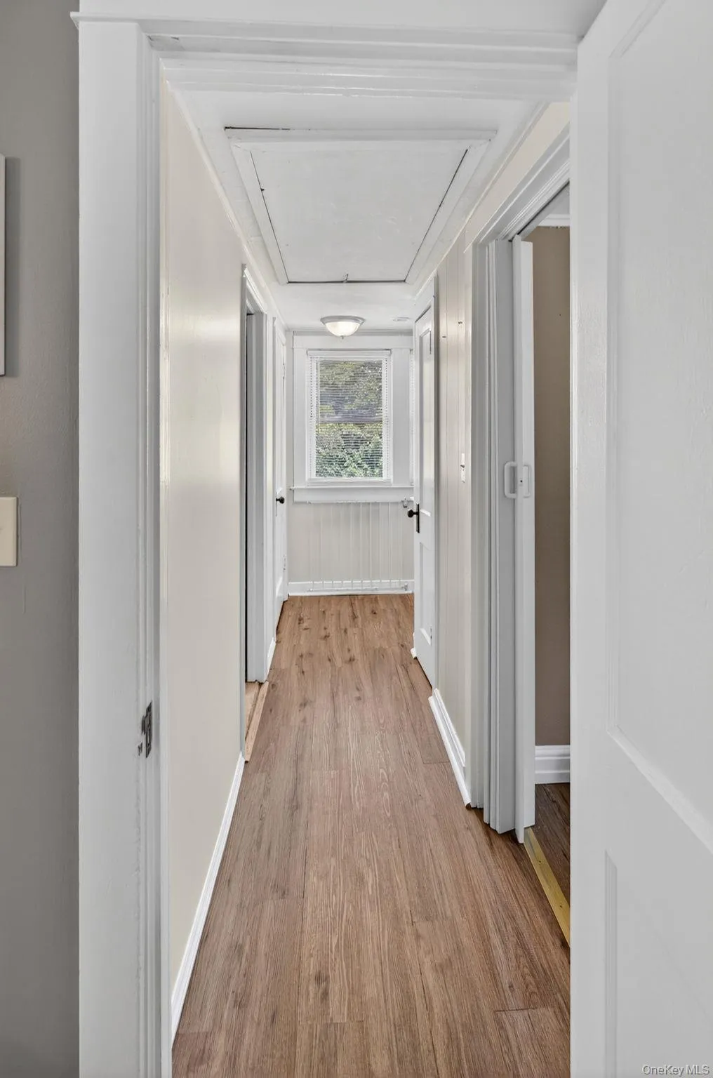 The upstairs hallway serves as a charming transition space, connecting the second-floor bedrooms while adding to the home's classic Cape Cod character. The upstairs hallway serves as a charming transition space, connecting the second-floor bedrooms while adding to the home's classic Cape Cod character.