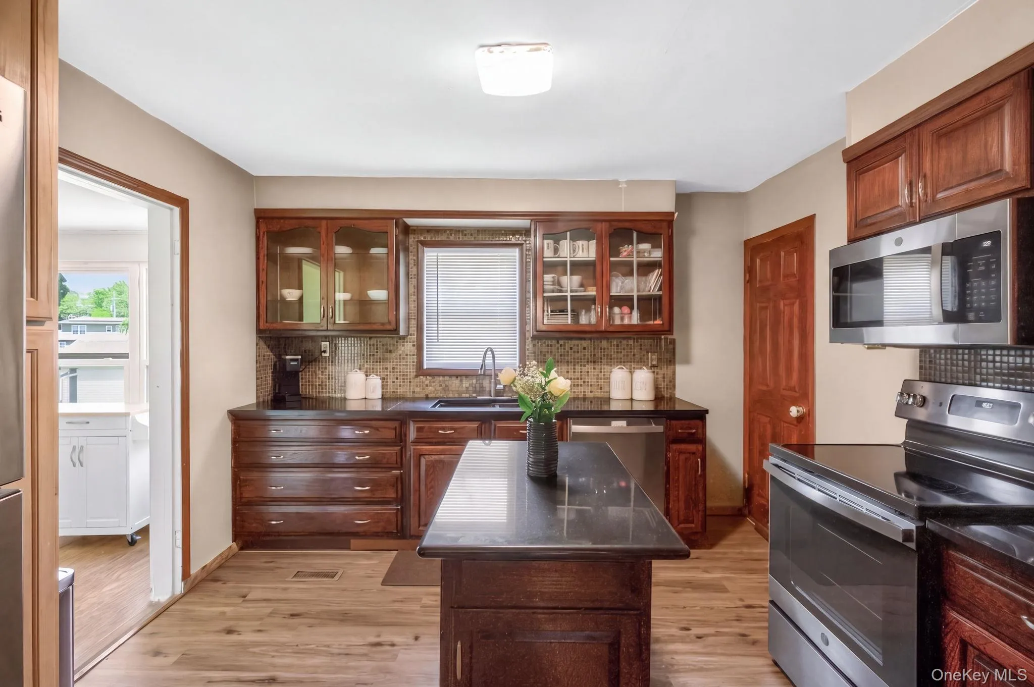 The kitchen is both stylish and functional, featuring sleek stainless steel appliances, beautiful granite countertops, and a spacious center island that serves as the heart of the room. The kitchen is both stylish and functional, featuring sleek stainless steel appliances, beautiful granite countertops, and a spacious center island that serves as the heart of the room.
