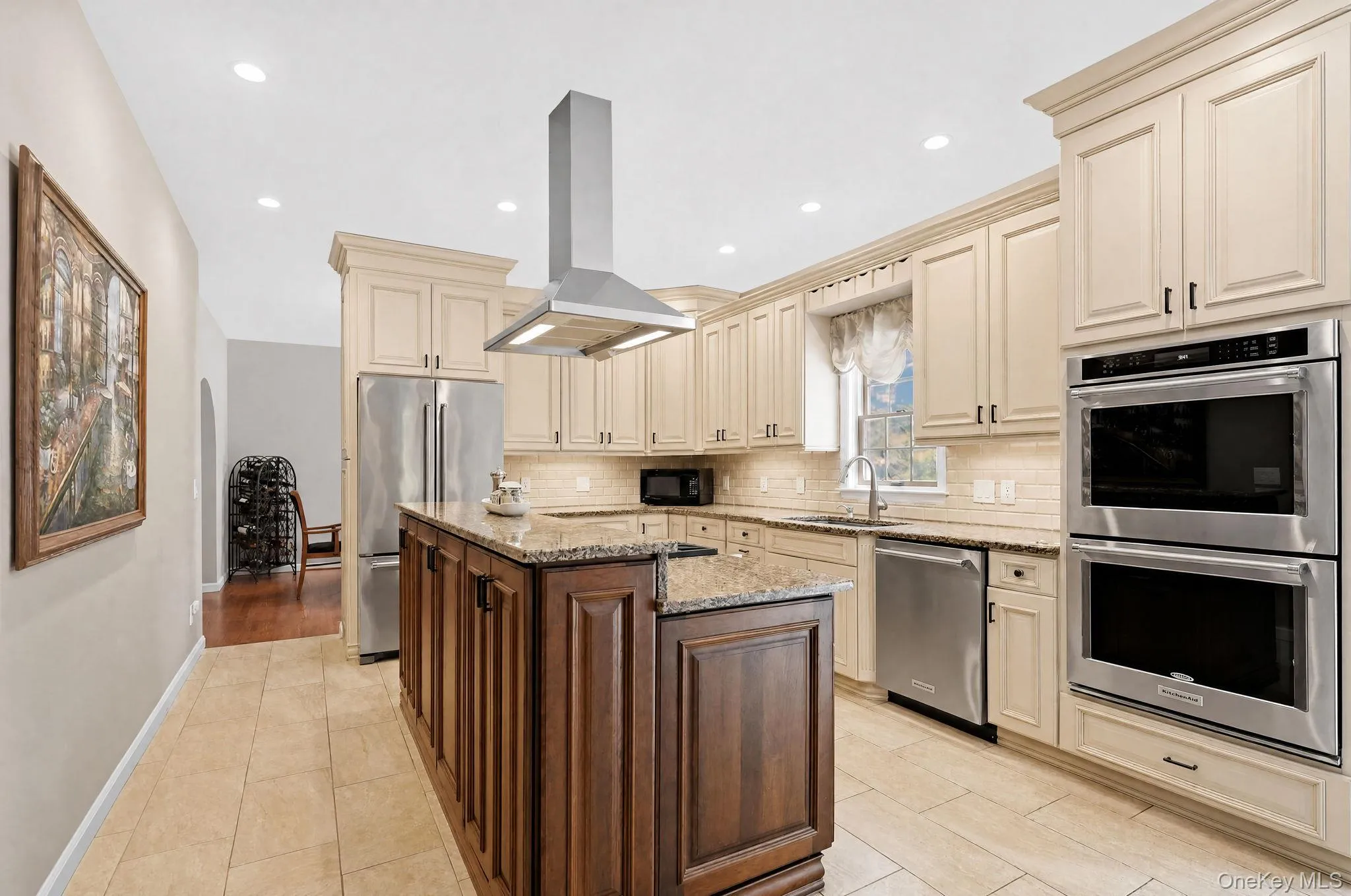 Custom kitchen with Wolf gas cooktop, KitchenAid double oven and refrigerator. Bosch dishwasher. Custom kitchen with Wolf gas cooktop, KitchenAid double oven and refrigerator. Bosch dishwasher.