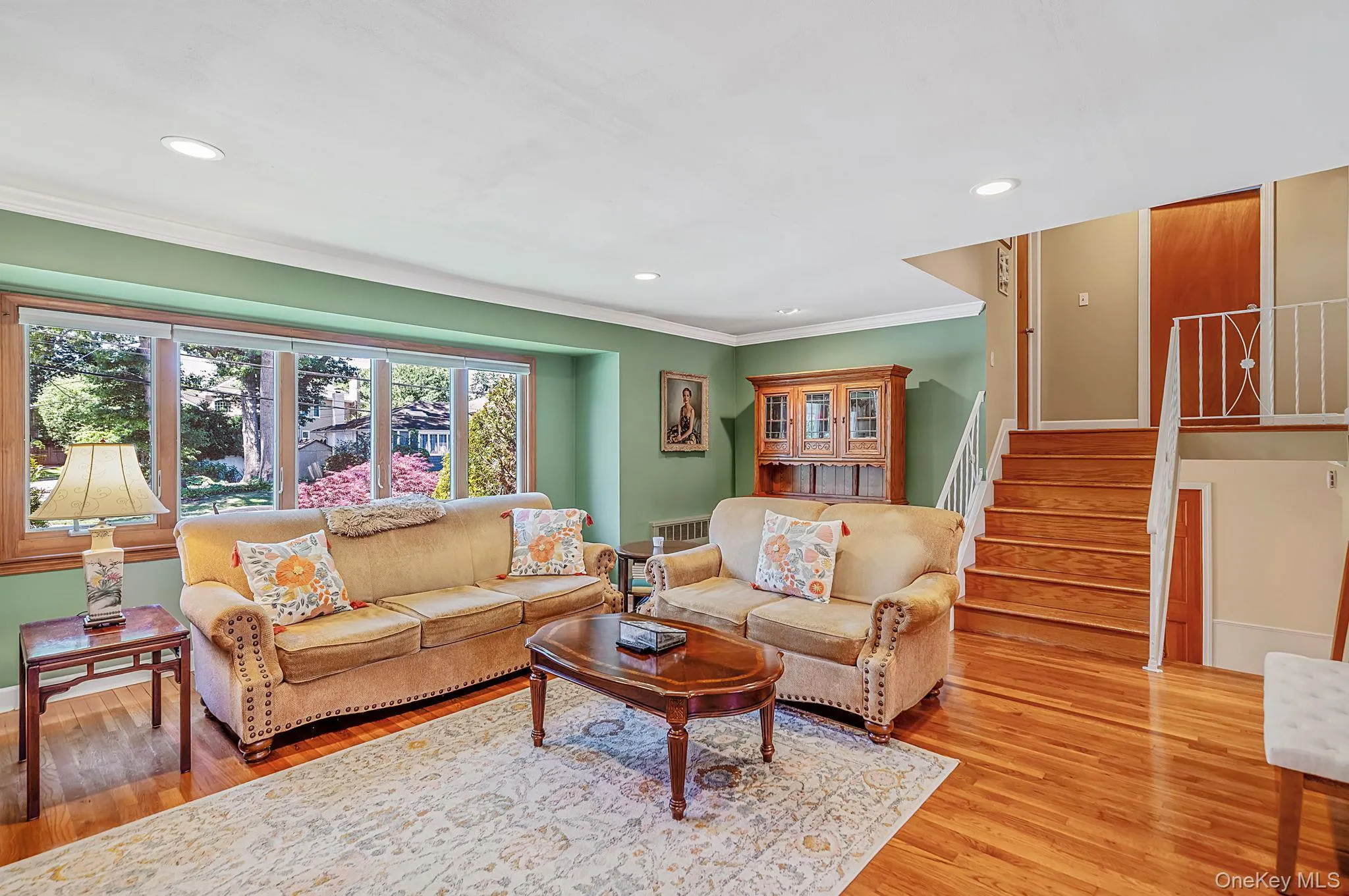 sunlit formal living room with gleaming hardwood floors sunlit formal living room with gleaming hardwood floors