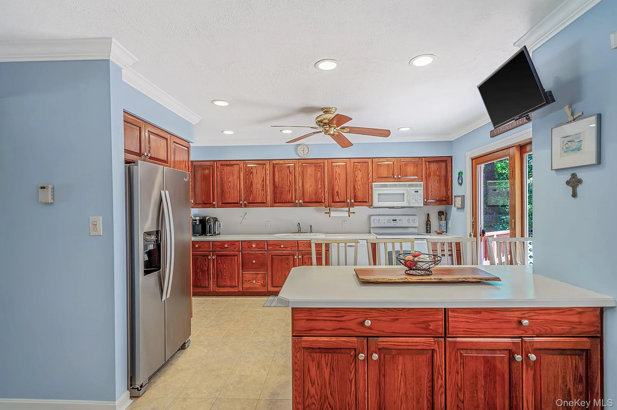 open layout kitchen with plenty of wood cabinets, pantry, and breakfast bar open layout kitchen with plenty of wood cabinets, pantry, and breakfast bar