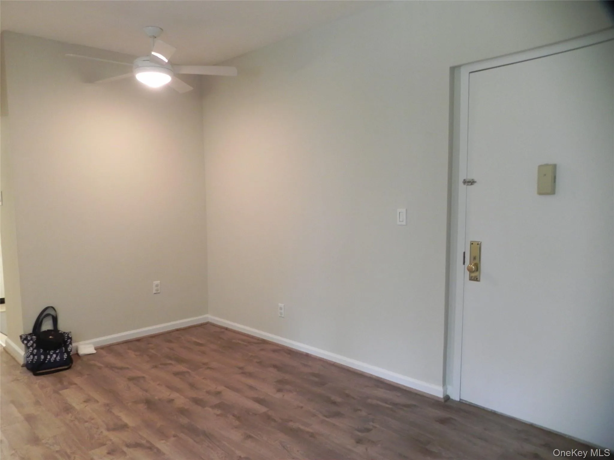 Room with wood finished floors and a ceiling fan Room with wood finished floors and a ceiling fan