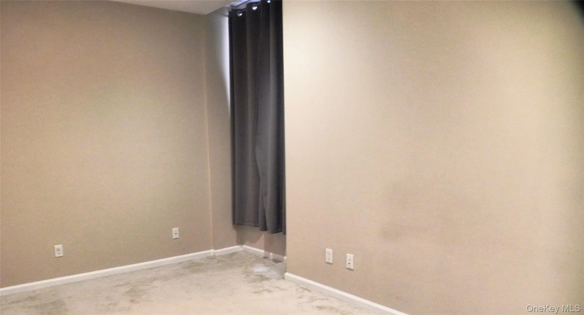 Unfurnished room with light colored carpet and baseboards Unfurnished room with light colored carpet and baseboards