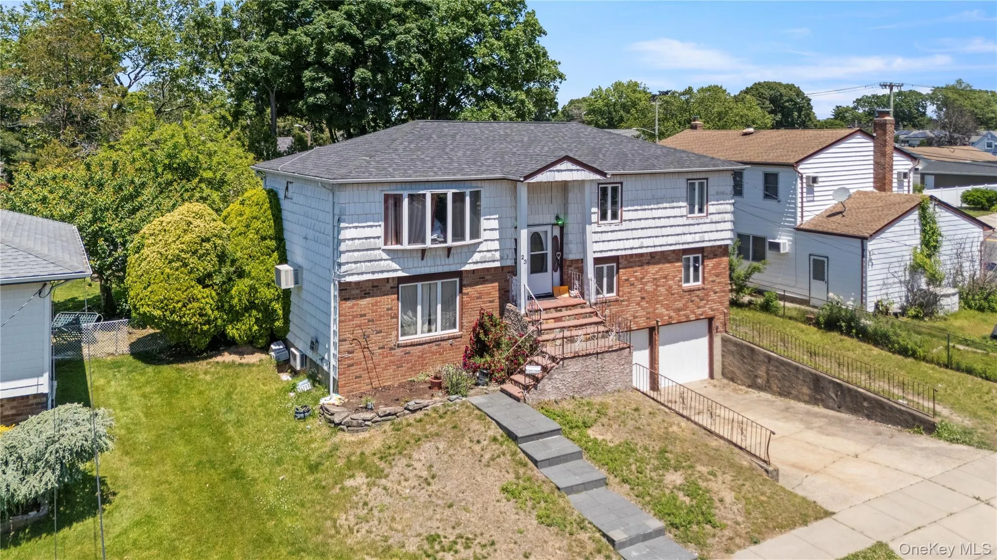 Three-Story residence featuring brick and siding facade Three-Story residence featuring brick and siding facade