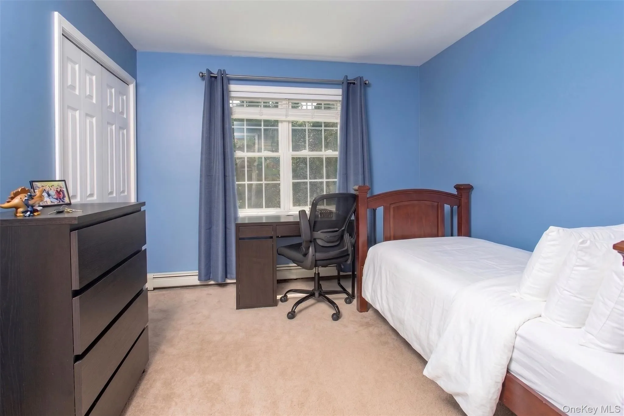 Bright second floor bedroom with full closet, one of four bedrooms on this level. Bedding virtually updated. Bright second floor bedroom with full closet, one of four bedrooms on this level. Bedding virtually updated.