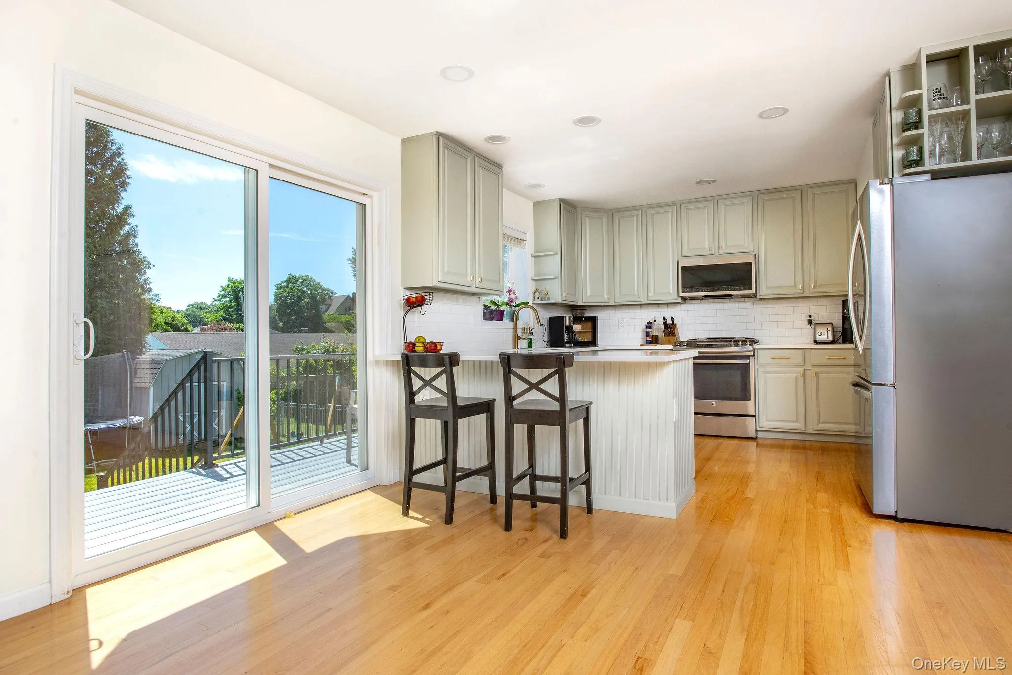 Spacious open plan kitchen and breakfast bar with updated sliding doors. Spacious open plan kitchen and breakfast bar with updated sliding doors.