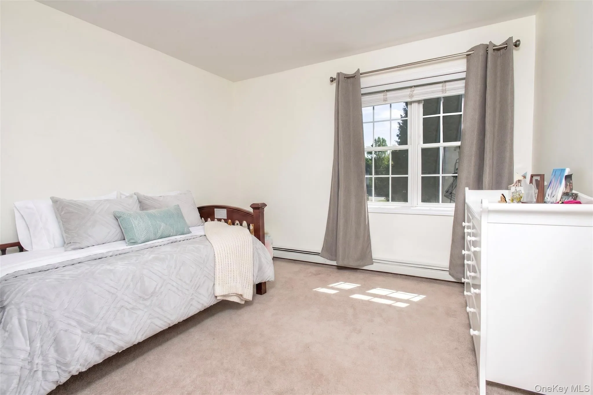 Light-filled second floor bedroom with full closet, one of four bedrooms on this level. Bedding virtually updated. Light-filled second floor bedroom with full closet, one of four bedrooms on this level. Bedding virtually updated.