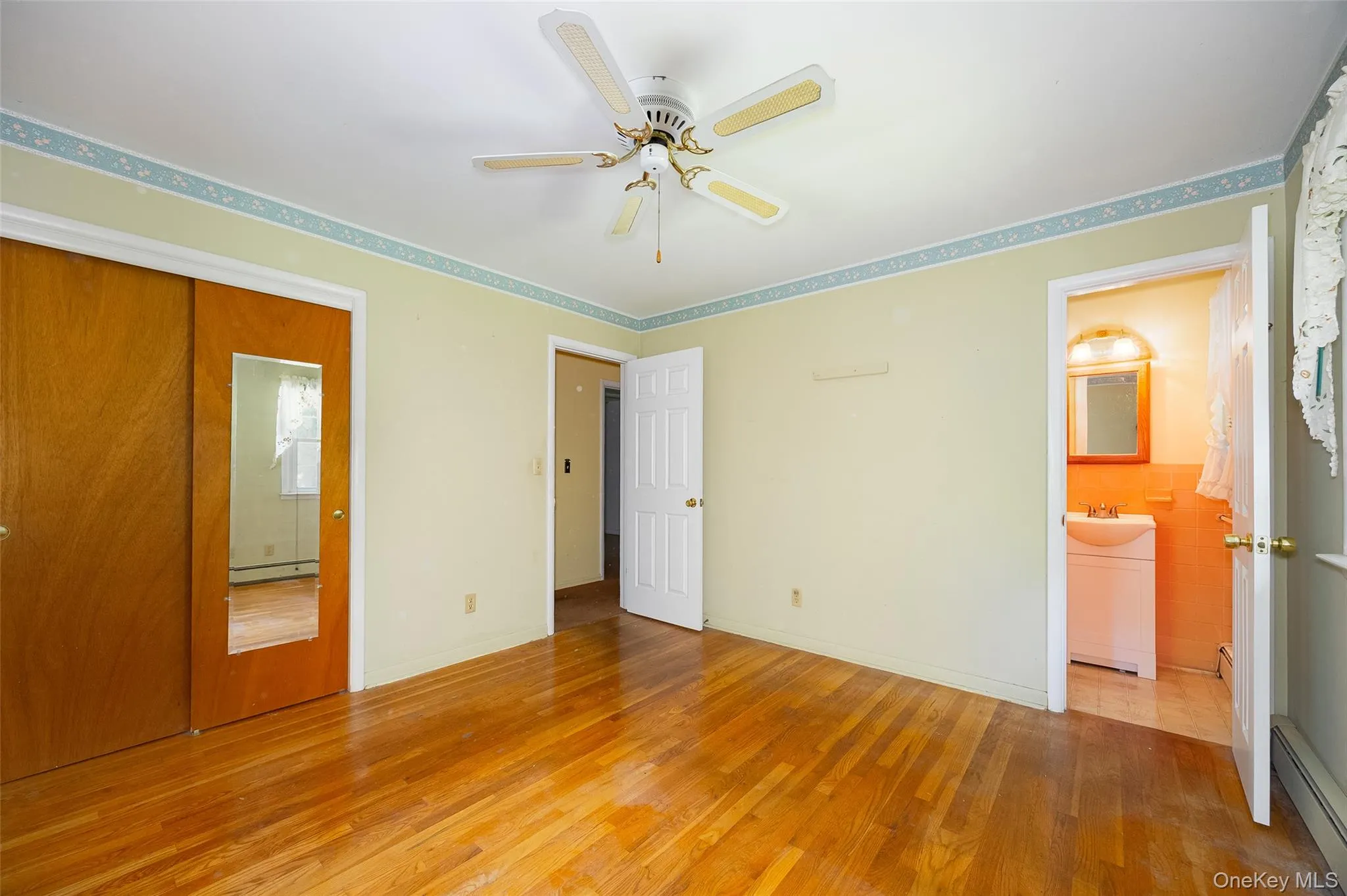 Large primary bedroom with a private half-bath en suite Large primary bedroom with a private half-bath en suite