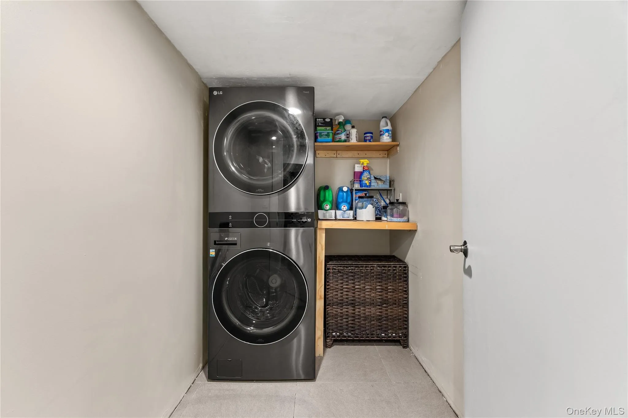 Dedicated laundry area featuring stacked front-loading appliances Dedicated laundry area featuring stacked front-loading appliances