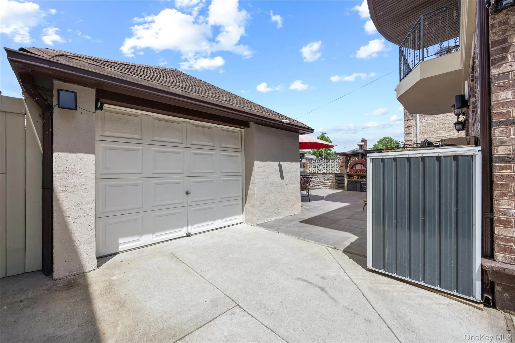 Detached garage with a paneled door and asphalt shingle roof Detached garage with a paneled door and asphalt shingle roof