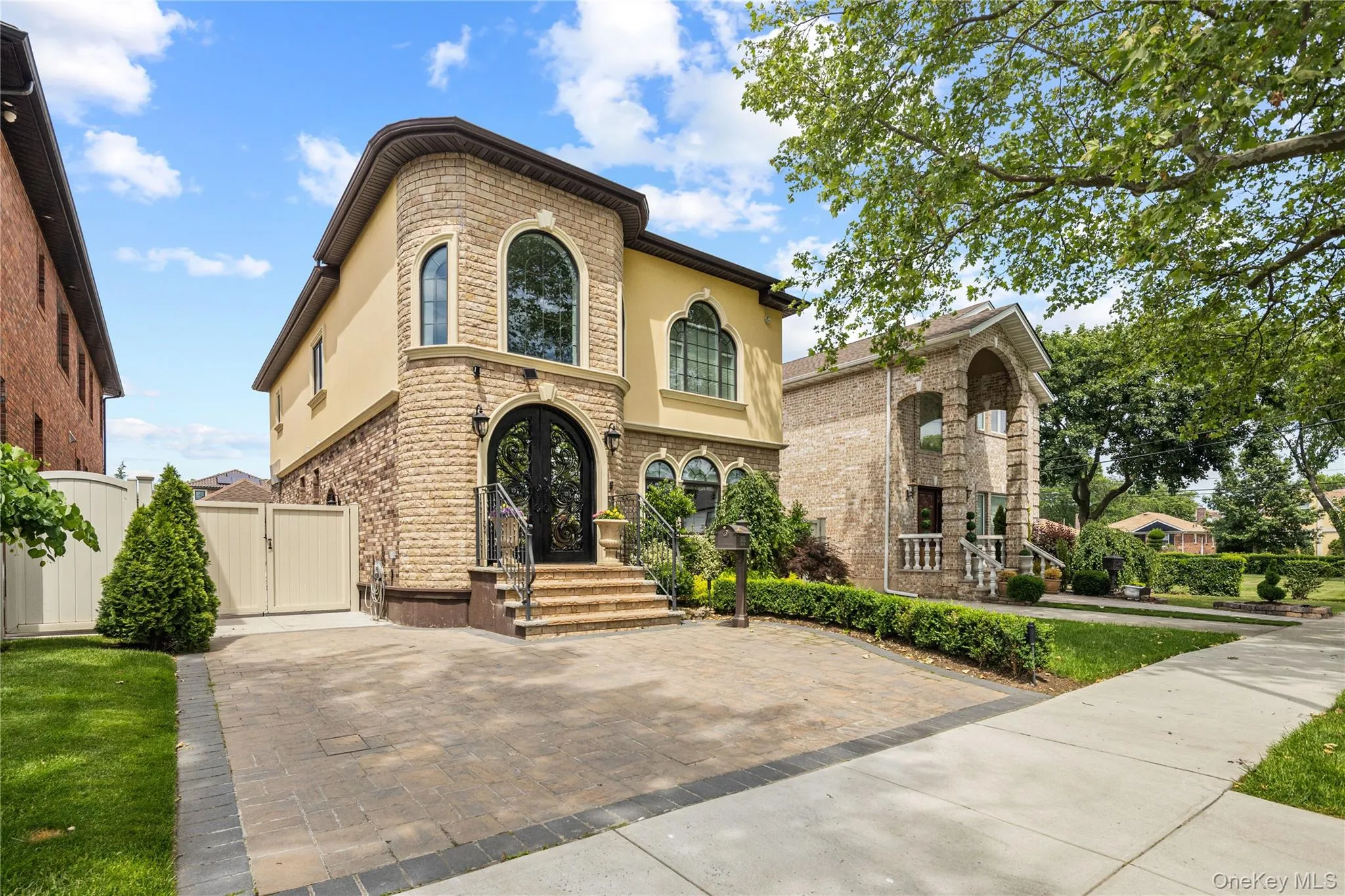 Mediterranean-inspired facade featuring stone veneer accents and stucco Mediterranean-inspired facade featuring stone veneer accents and stucco