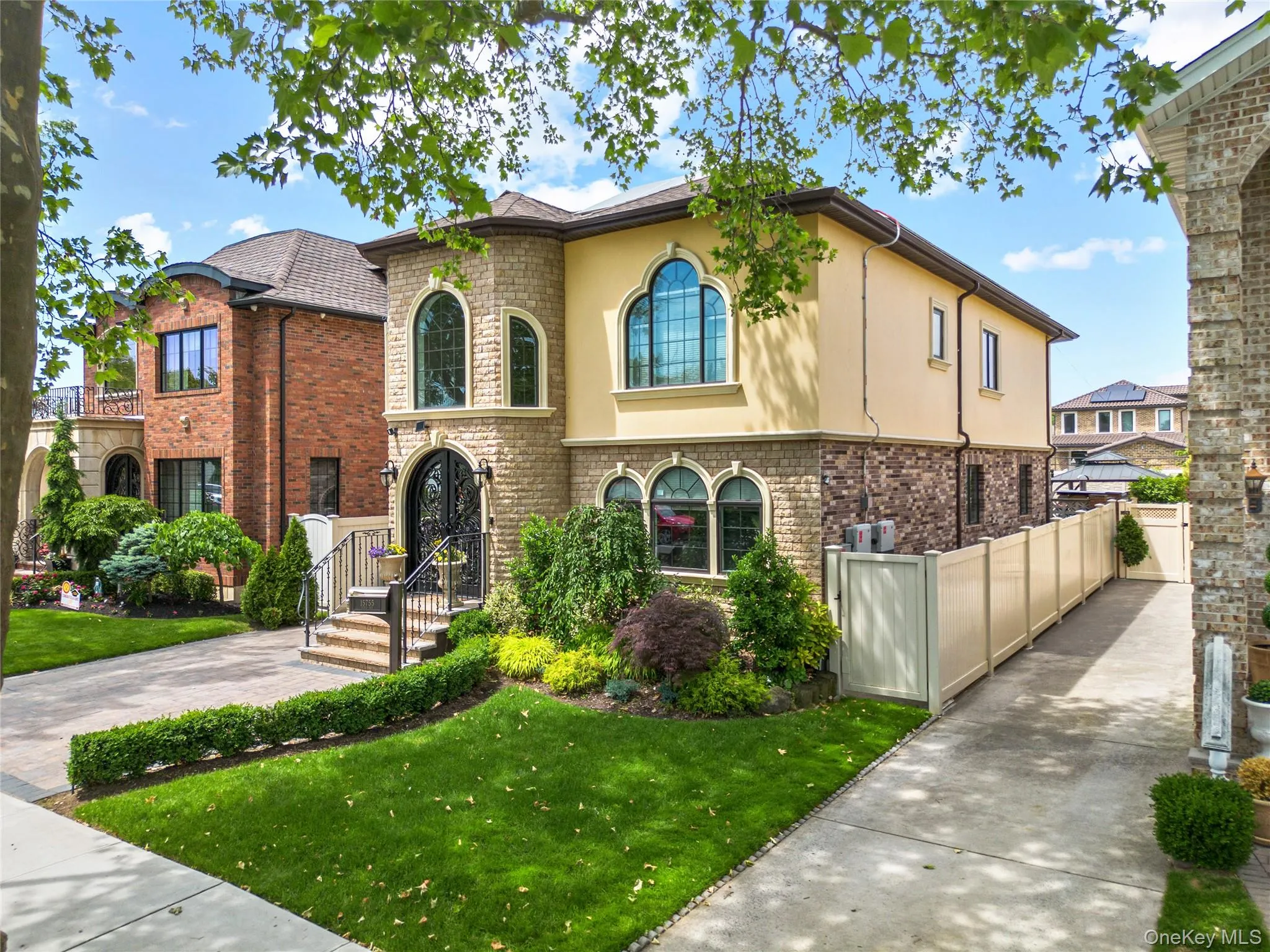 Stucco and stone facade with arched windows and a prominent entry Stucco and stone facade with arched windows and a prominent entry
