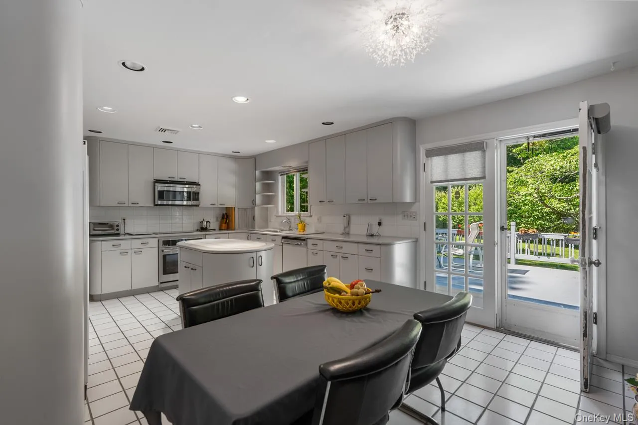 Kitchen leads onto the large deck and backyard Kitchen leads onto the large deck and backyard