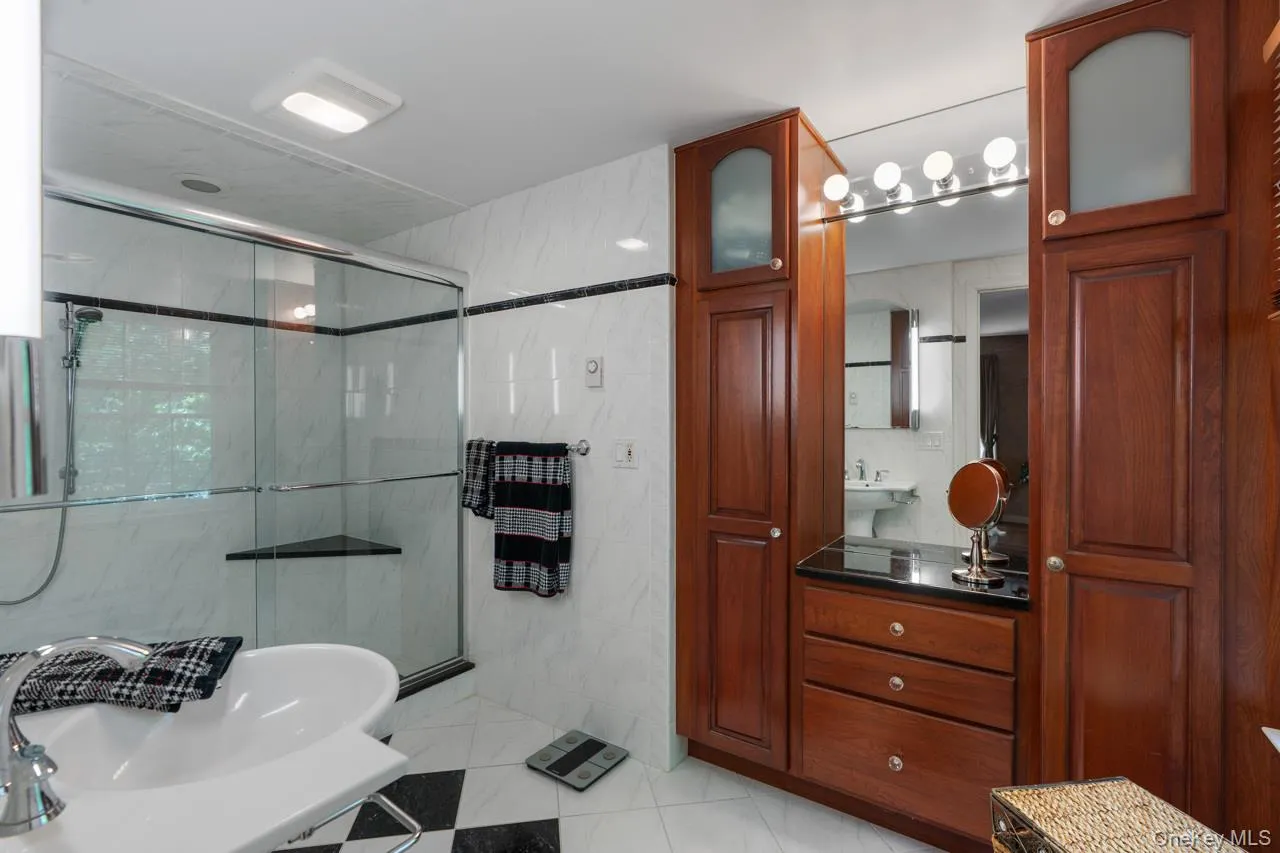 Elegant bathroom with custom-designed built in cherry cabinetry Elegant bathroom with custom-designed built in cherry cabinetry