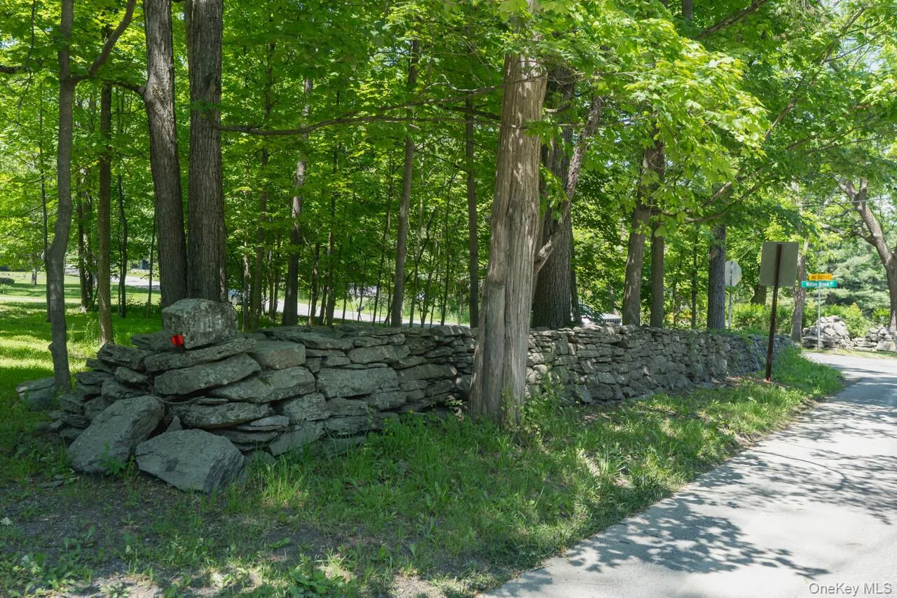 Stone wall lines the property at the road and along the property line Stone wall lines the property at the road and along the property line