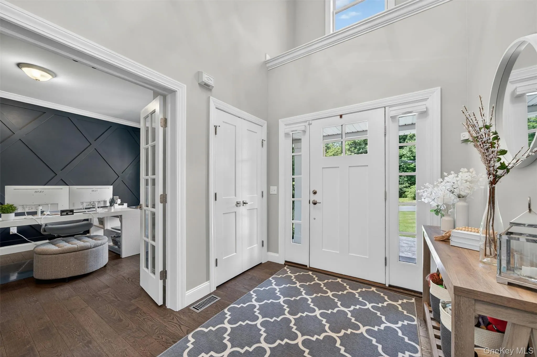 Two-story foyer featuring an arched entryway and a transom window Two-story foyer featuring an arched entryway and a transom window