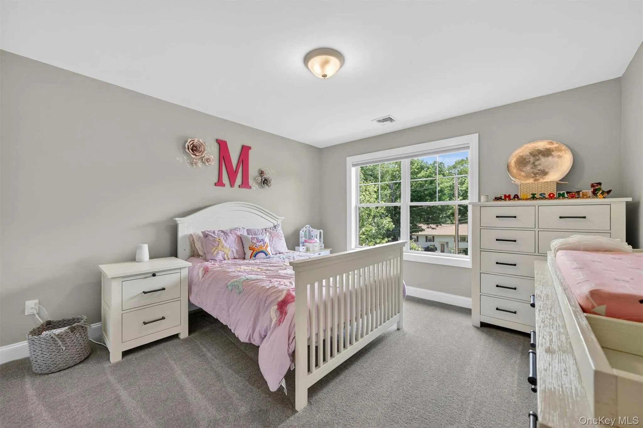 Room featuring neutral gray walls, light gray carpeting, and a white trim window Room featuring neutral gray walls, light gray carpeting, and a white trim window