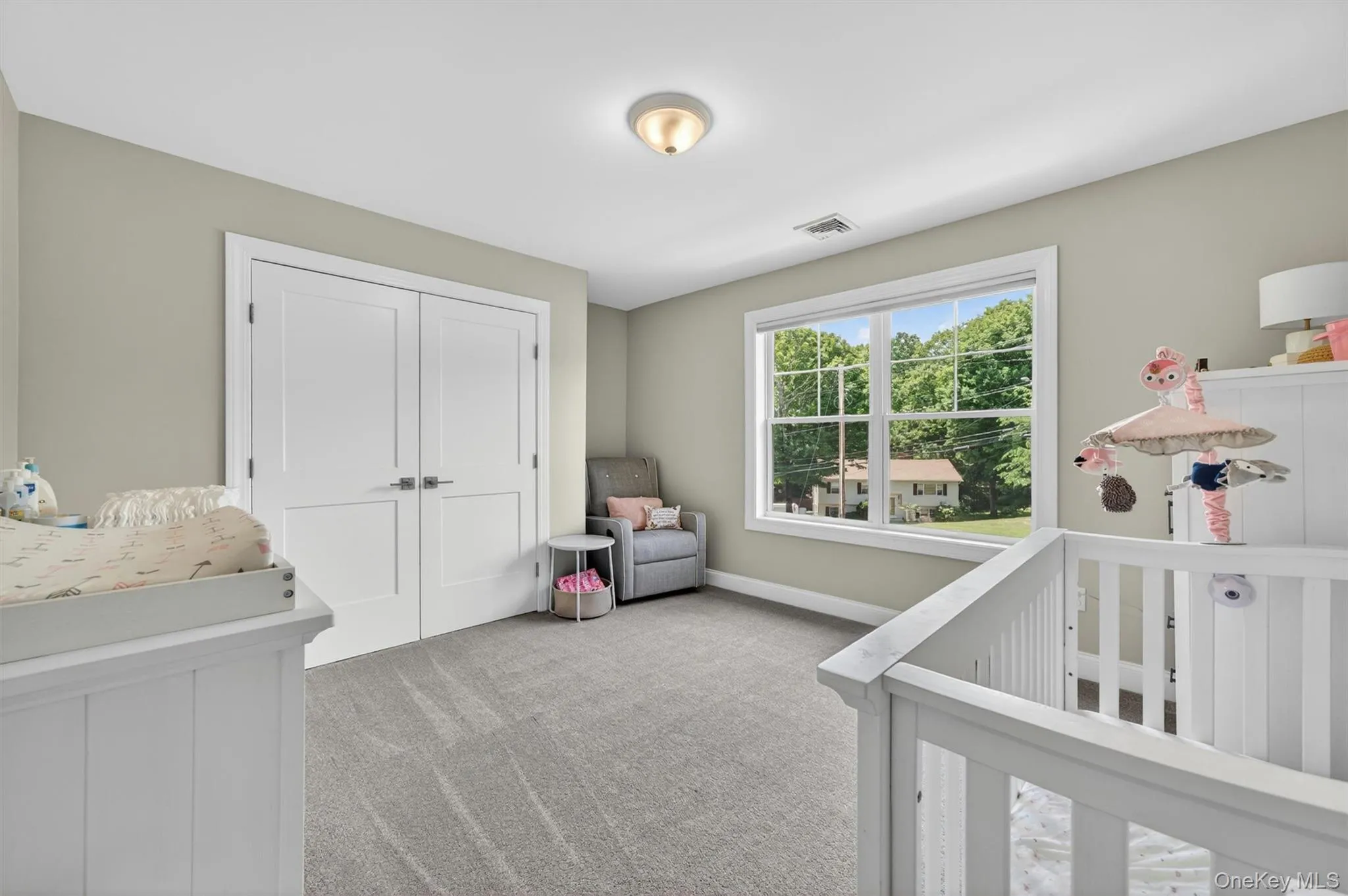 Room featuring light-toned walls, white trim, and gray carpet flooring Room featuring light-toned walls, white trim, and gray carpet flooring