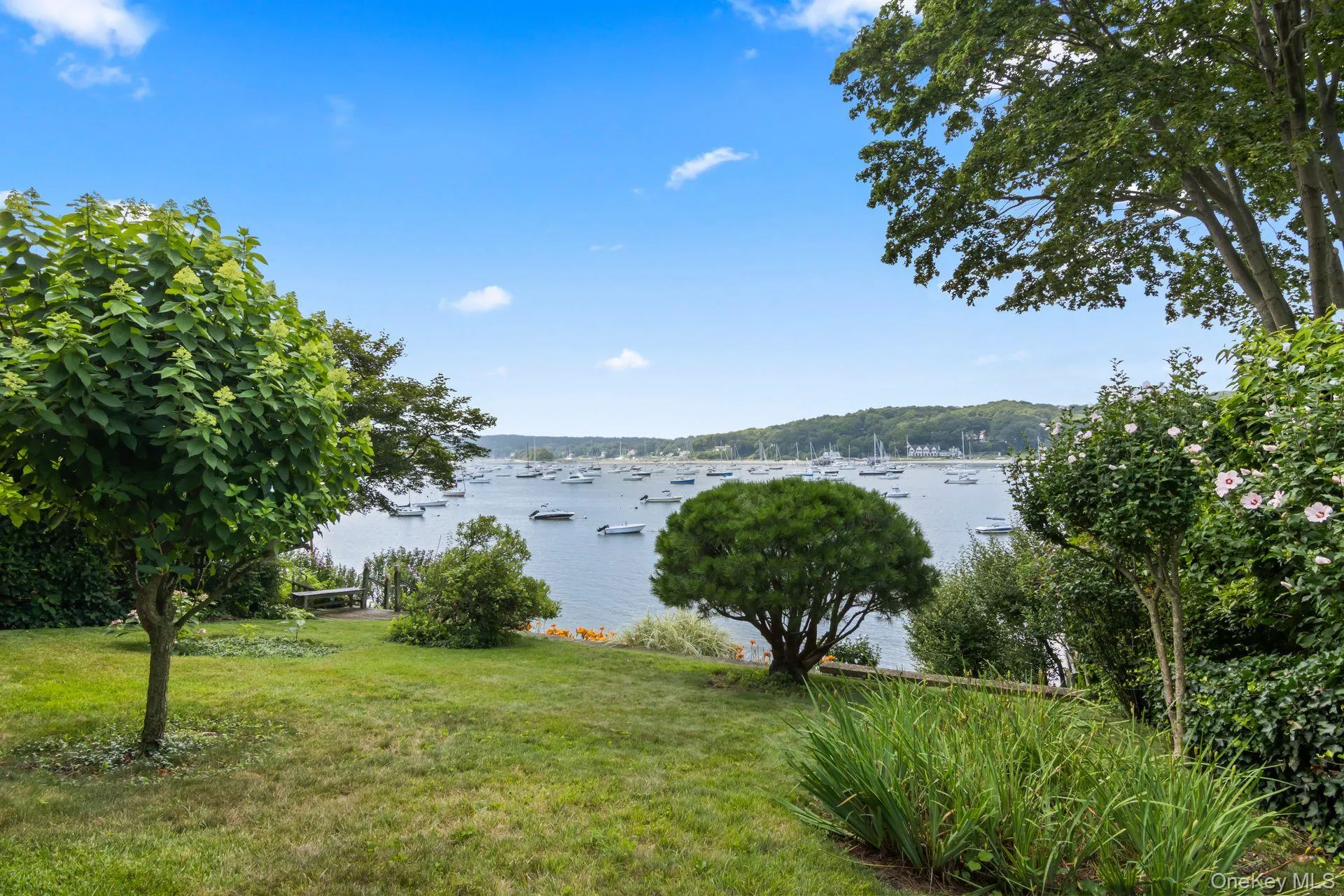 Lush lawn and manicured gardens leading to the waterfront Lush lawn and manicured gardens leading to the waterfront