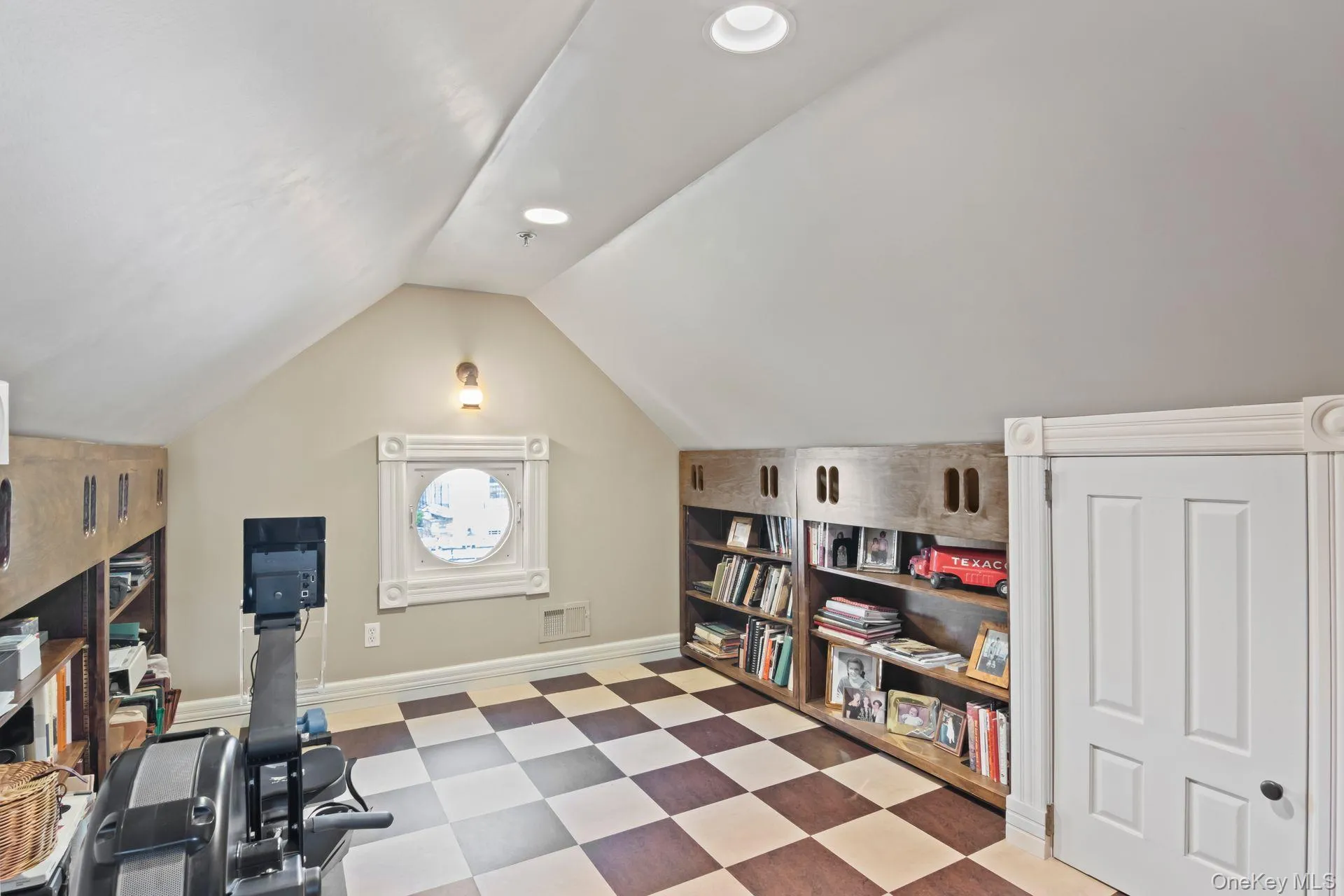 Versatile third-floor flex space with custom built-ins, a charming porthole window, and endless possibilities as a home gym, hobby room, or private retreat Versatile third-floor flex space with custom built-ins, a charming porthole window, and endless possibilities as a home gym, hobby room, or private retreat
