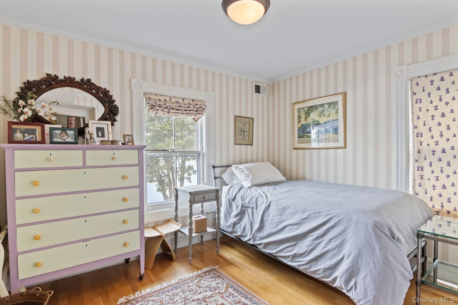Spacious guest bedroom with abundant natural light and stunning water views Spacious guest bedroom with abundant natural light and stunning water views