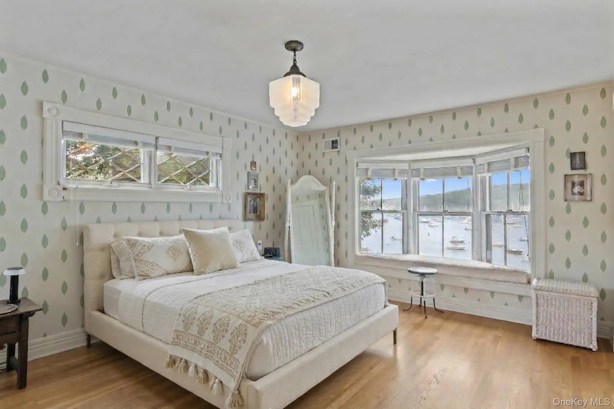 Primary bedroom with sweeping water views Primary bedroom with sweeping water views