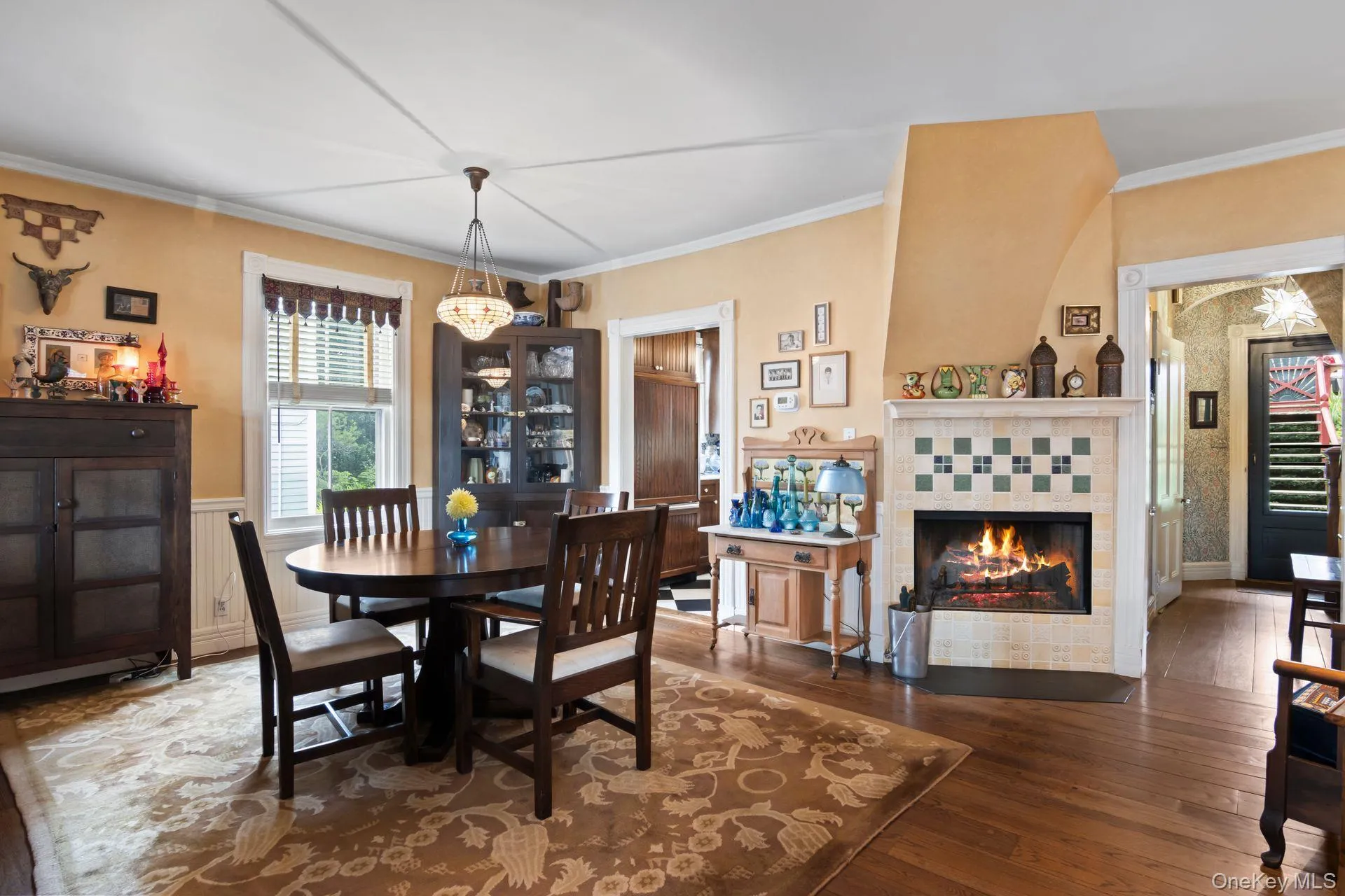 Open floor plan seamlessly connecting the living room, dining room, and kitchen, highlighted by a cozy wood-burning fireplace in the living room. Open floor plan seamlessly connecting the living room, dining room, and kitchen, highlighted by a cozy wood-burning fireplace in the living room.