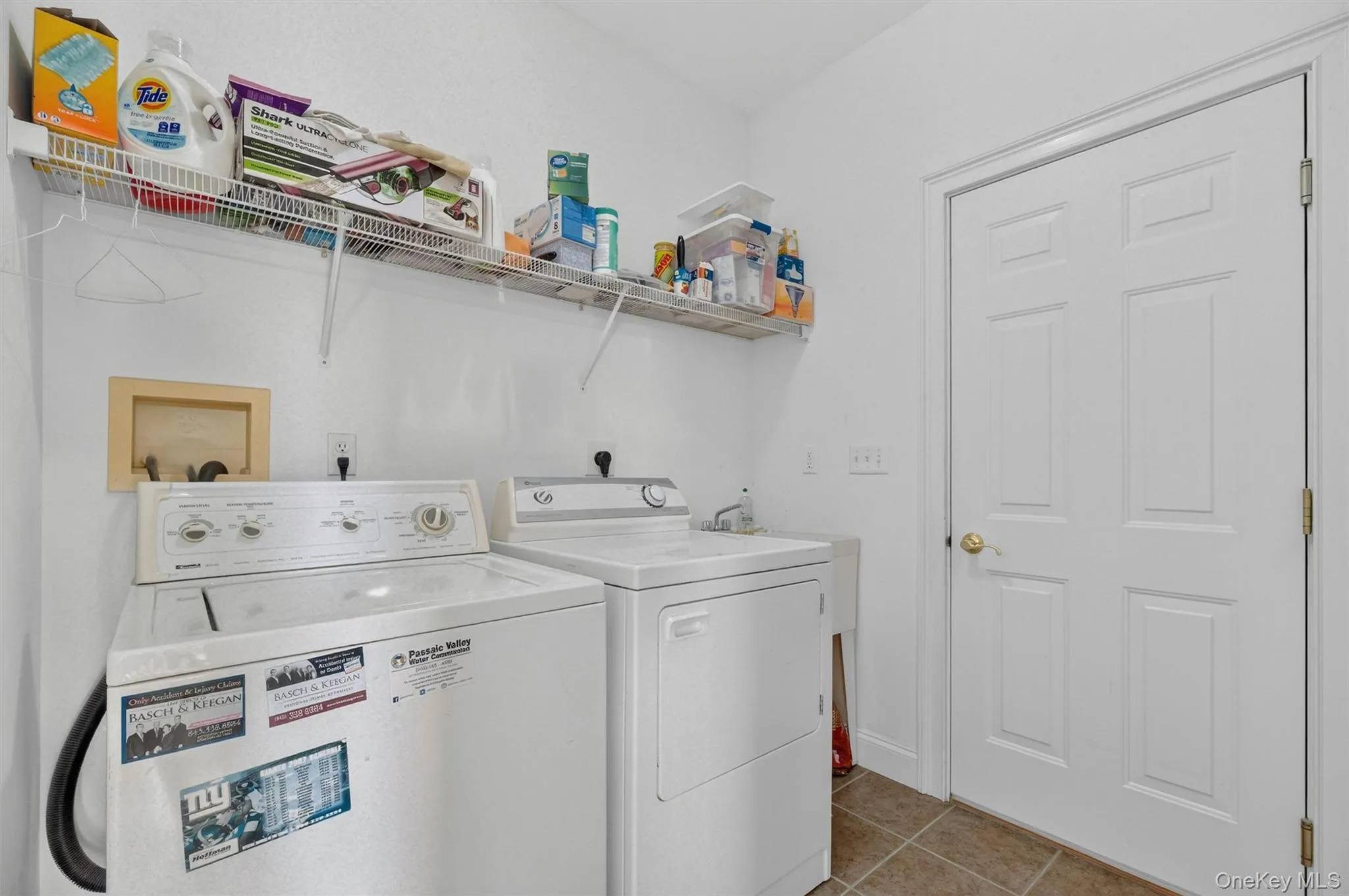 Laundry room conveniently off the garage includes washer, dryer, slop sink and shelving Laundry room conveniently off the garage includes washer, dryer, slop sink and shelving