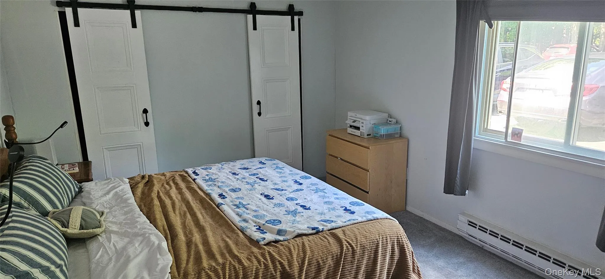 Spacious room featuring light-toned walls and grey carpeting Spacious room featuring light-toned walls and grey carpeting