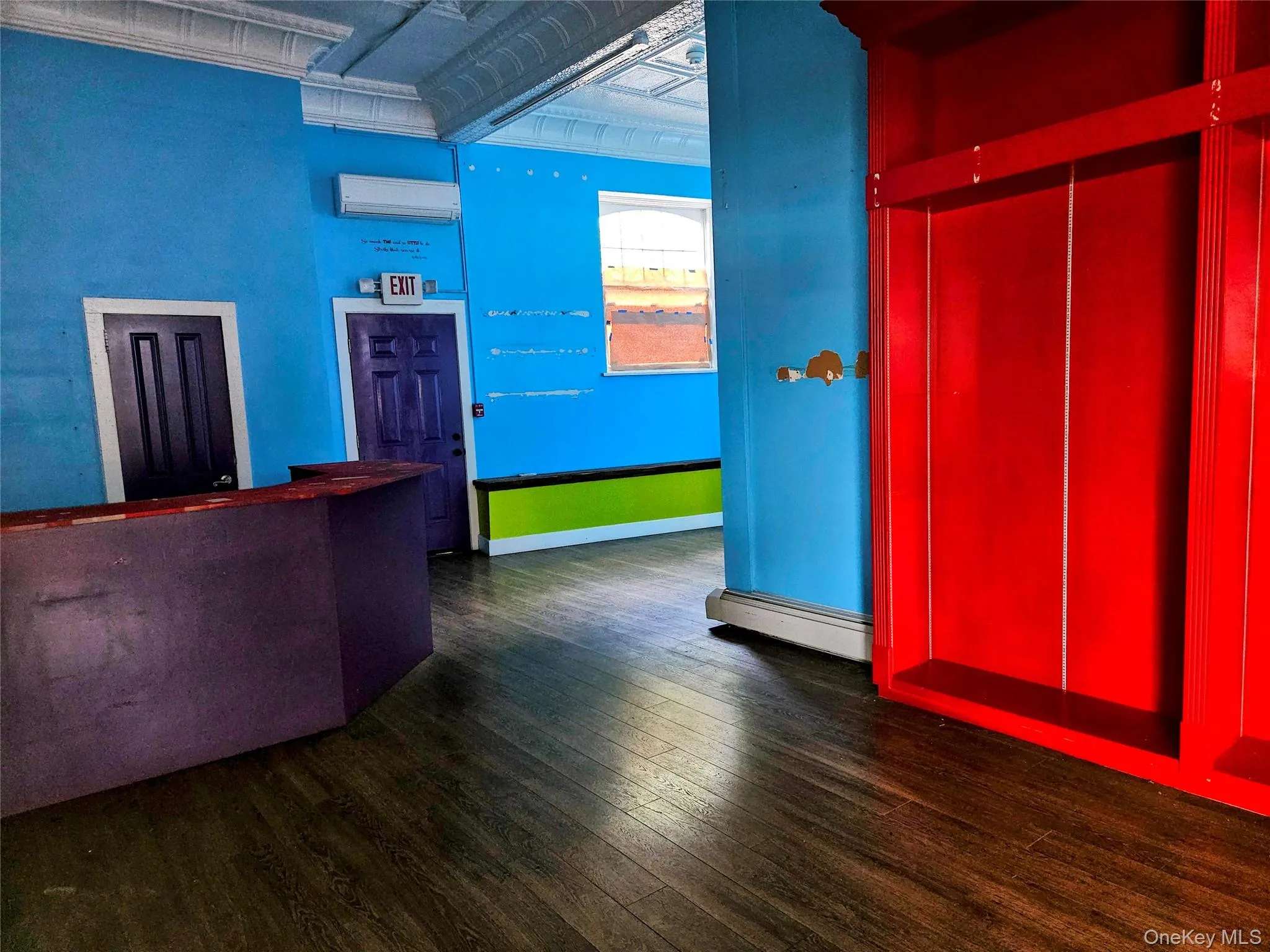 Service counter, rear door for delivery and 2 dedicated on-site parking spaces, with even more floor space to the right. Door to bathroom 1 is behind the service counter. Service counter, rear door for delivery and 2 dedicated on-site parking spaces, with even more floor space to the right. Door to bathroom 1 is behind the service counter.
