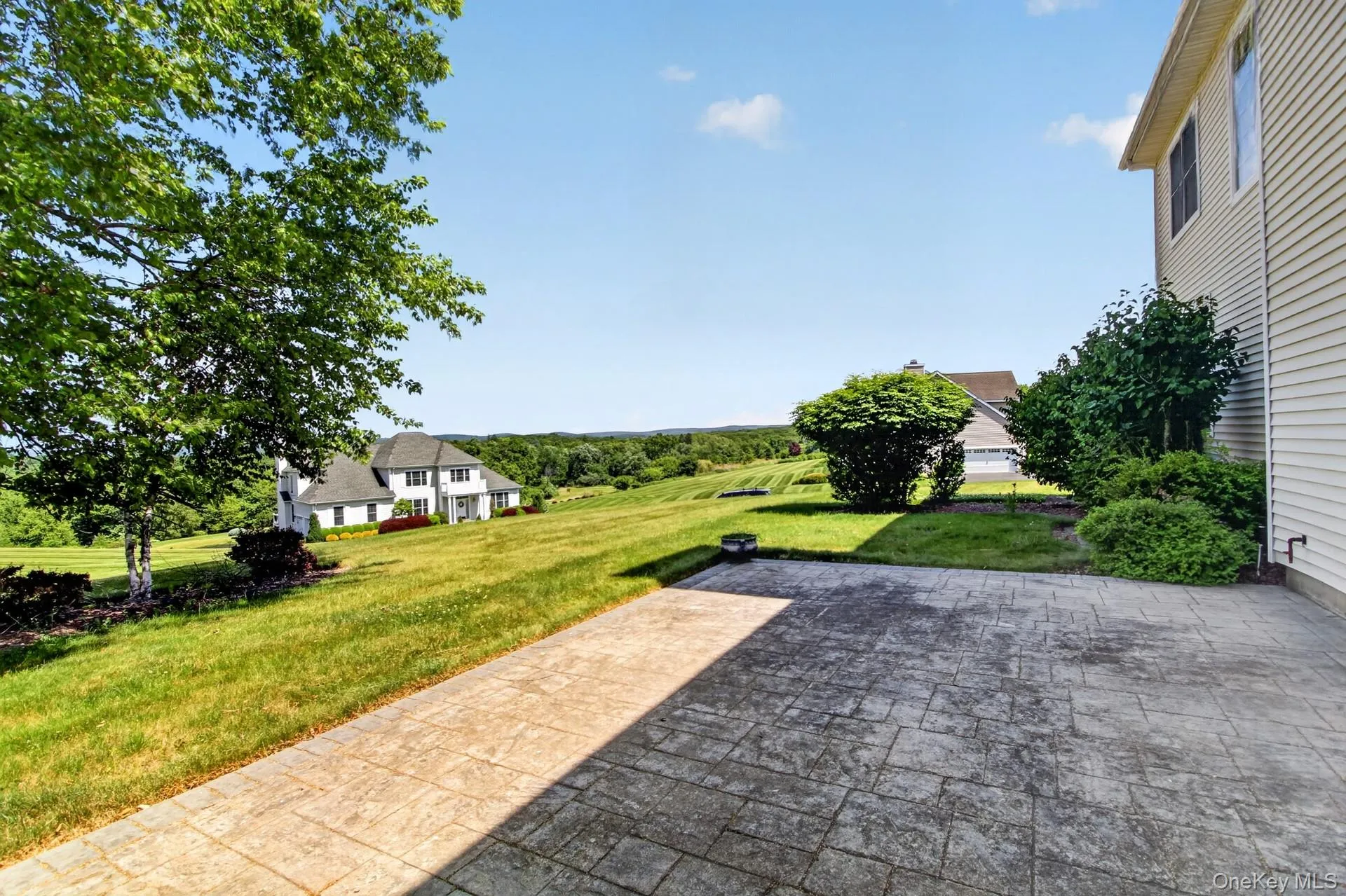 Stamped concrete patio providing extensive outdoor living space Stamped concrete patio providing extensive outdoor living space