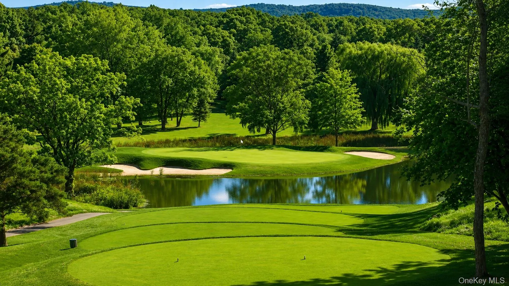 Expansive golf course setting featuring lush green fairways and a serene water hazard Expansive golf course setting featuring lush green fairways and a serene water hazard