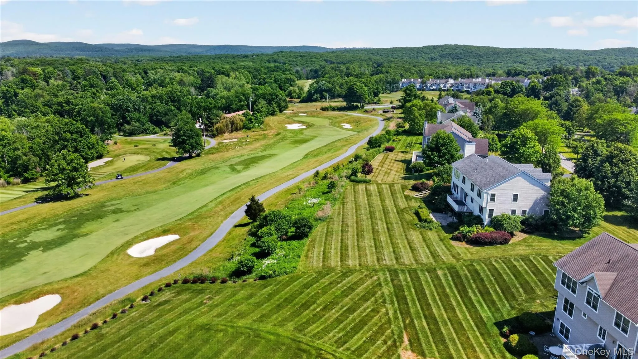 Expansive golf course frontage featuring manicured greens and sand bunkers Expansive golf course frontage featuring manicured greens and sand bunkers