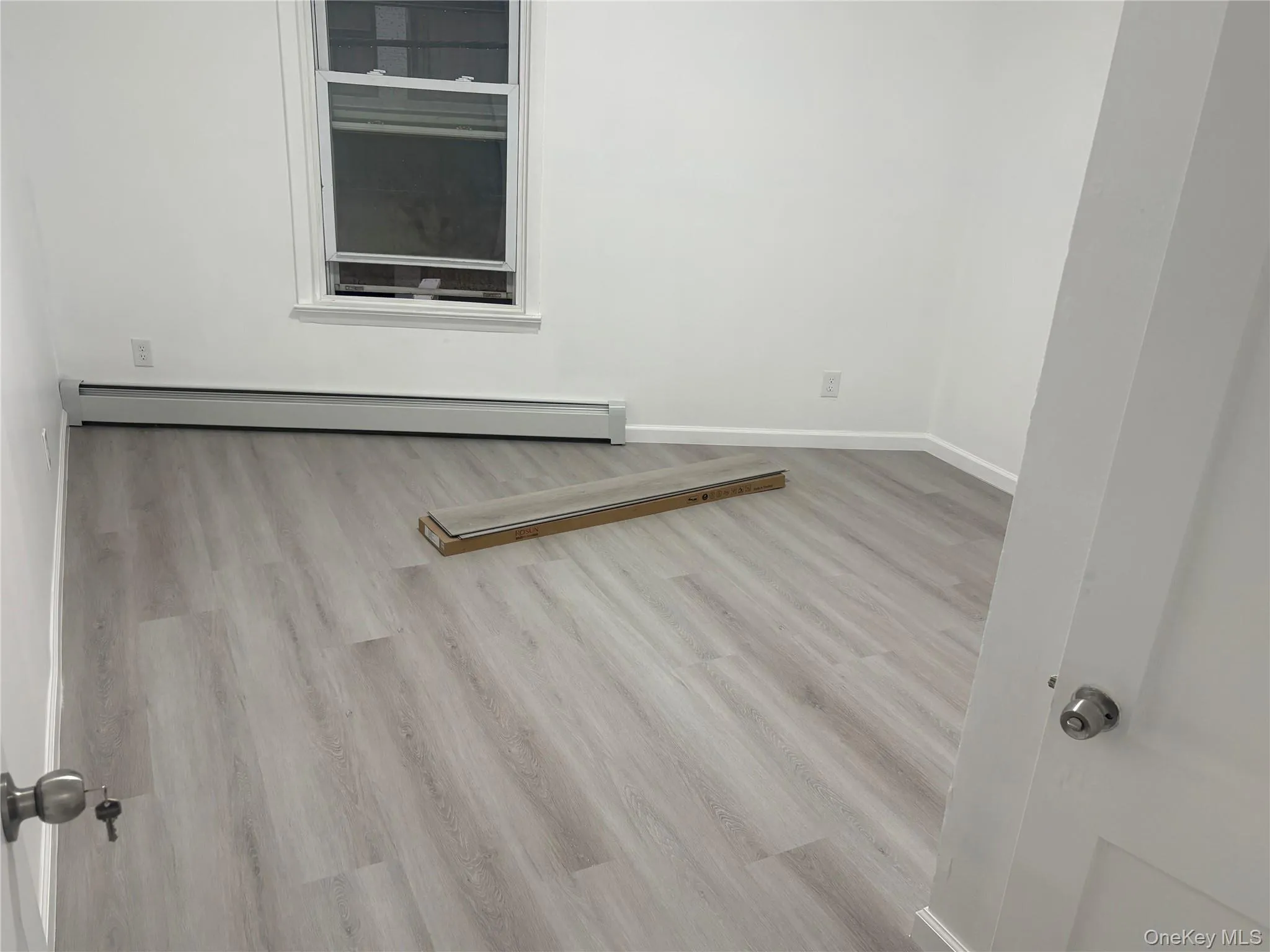 Spacious bedroom with new flooring, fresh paint, and abundant natural light. Spacious bedroom with new flooring, fresh paint, and abundant natural light.
