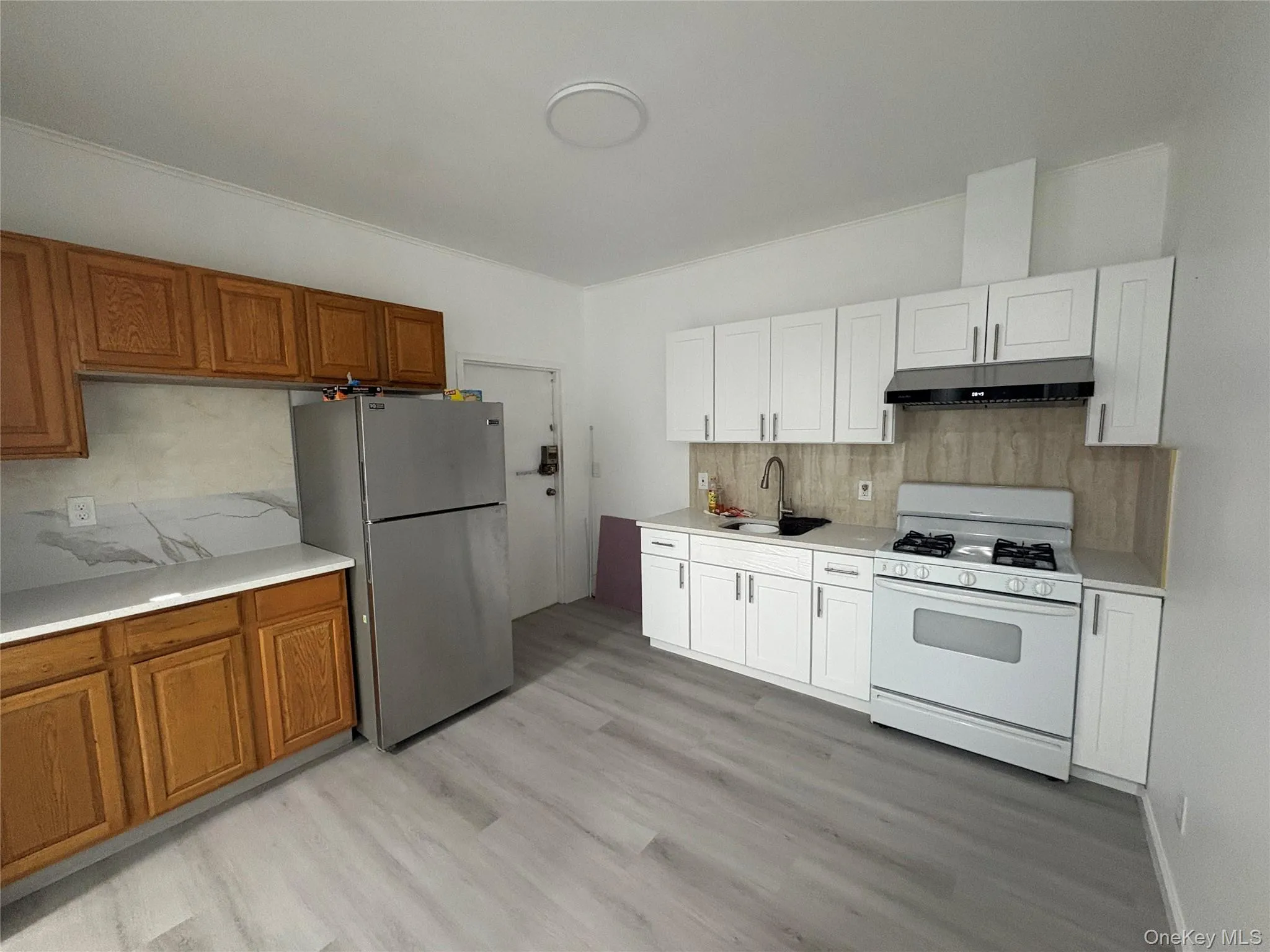Completely renovated kitchen featuring updated cabinetry, modern appliances, and plenty of storage space. Completely renovated kitchen featuring updated cabinetry, modern appliances, and plenty of storage space.
