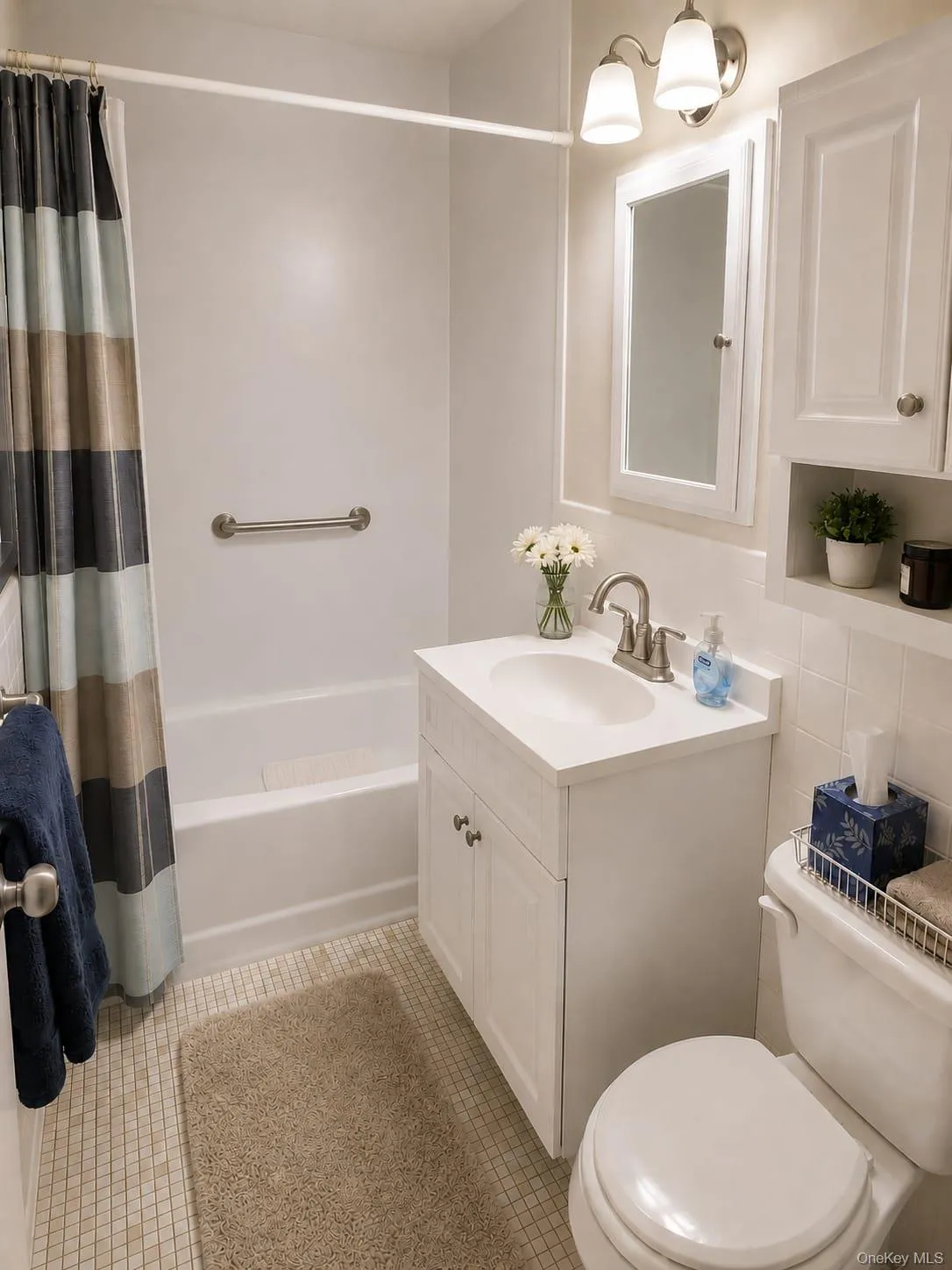 Full on-suite bath with newer shower/bath wrap around for easy cleaning and safety hand rails Full on-suite bath with newer shower/bath wrap around for easy cleaning and safety hand rails
