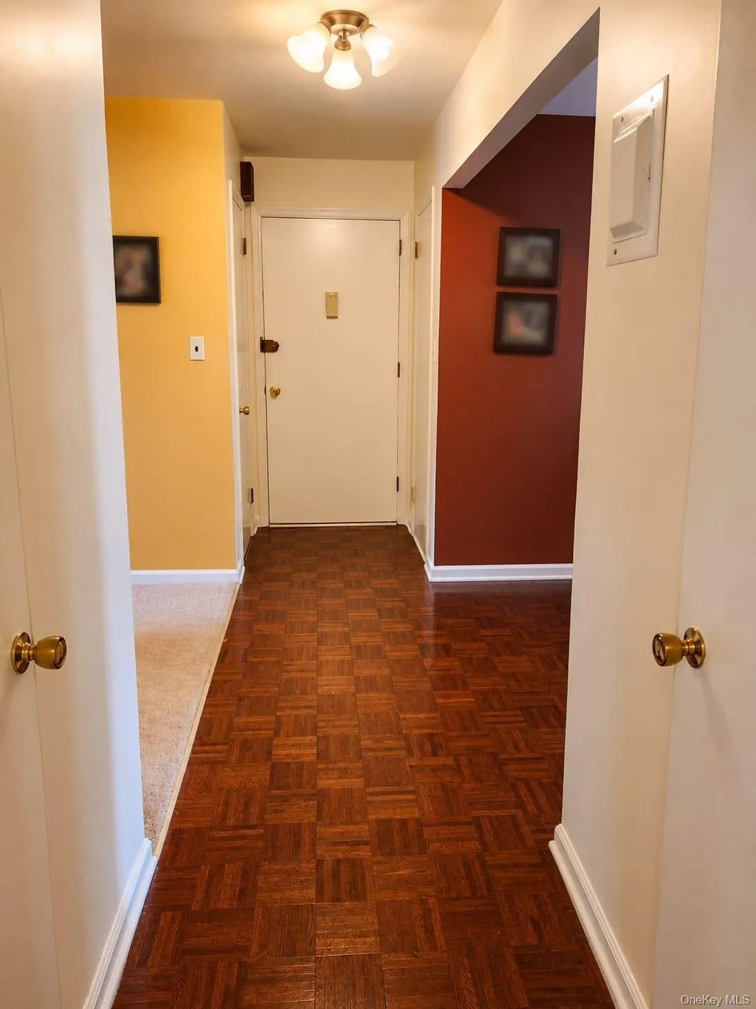 Hallway from bedroom door to front door with lavatory on 1 side and large closet on the other Hallway from bedroom door to front door with lavatory on 1 side and large closet on the other