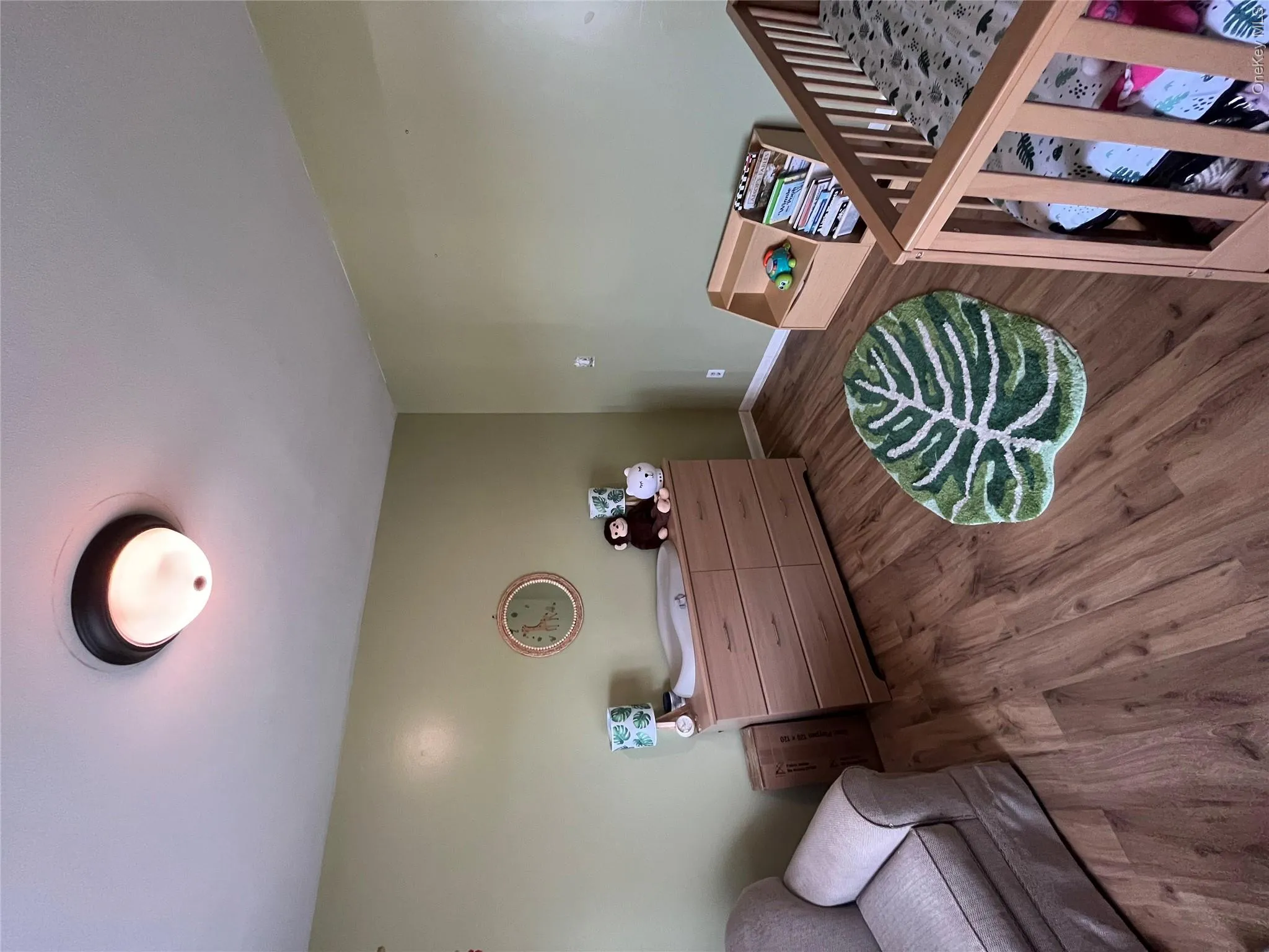 Second Bedroom featuring wood-finish flooring, a neutral wall color, and a ceiling-mounted light fixture Second Bedroom featuring wood-finish flooring, a neutral wall color, and a ceiling-mounted light fixture