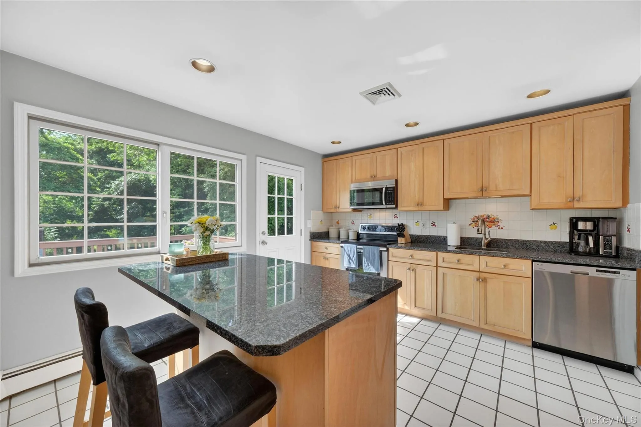 Spacious custom kitchen with large window and a door to the deck. Spacious custom kitchen with large window and a door to the deck.